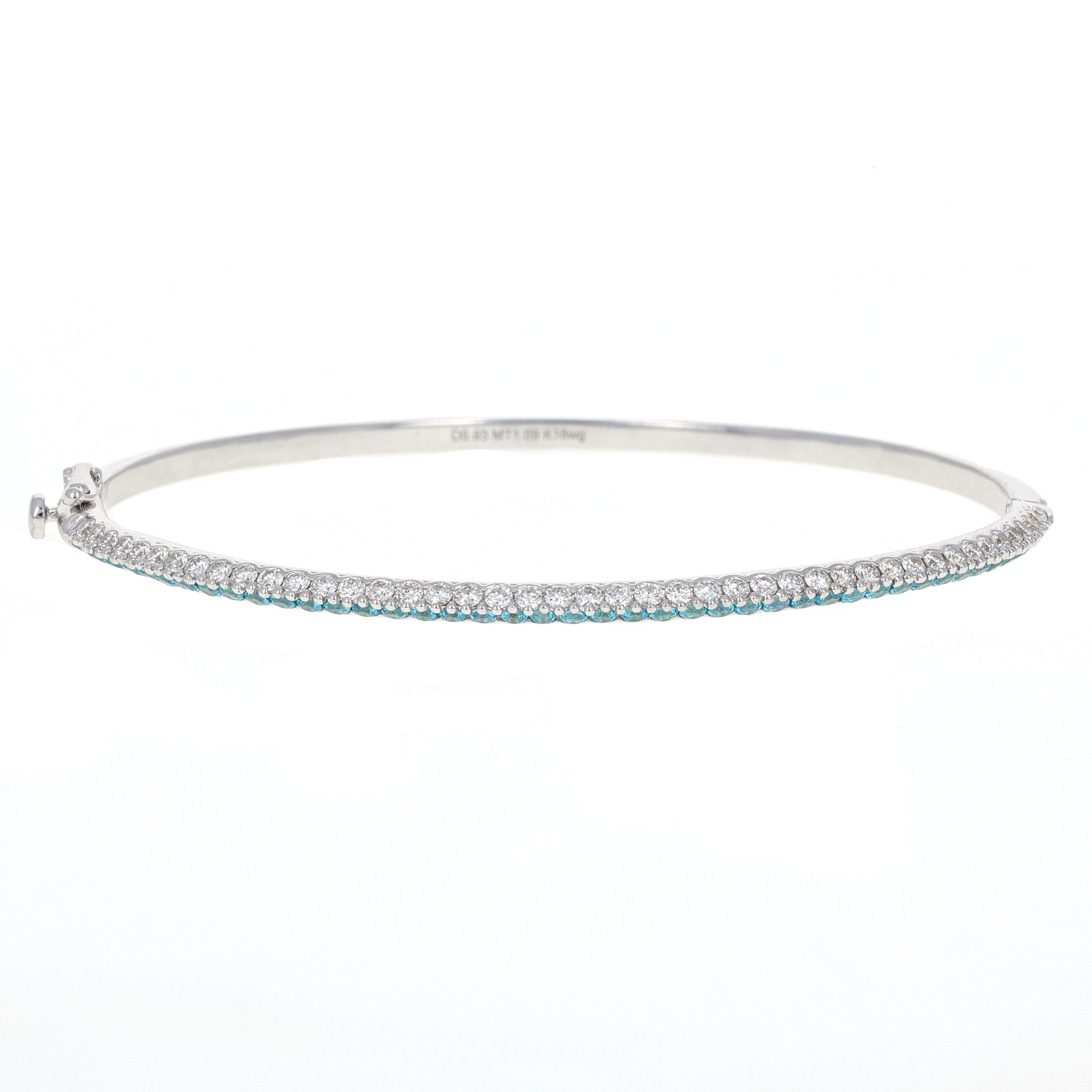 Beautiful stacking diamond and topaz bangle bracelet with a stylish knife edge. The bangle has 44 round brilliant white diamonds weighing a total of 0.93 carats and 44 mystic topaz stones weighing a total of 1.09 carats.
This bangle is very unique,