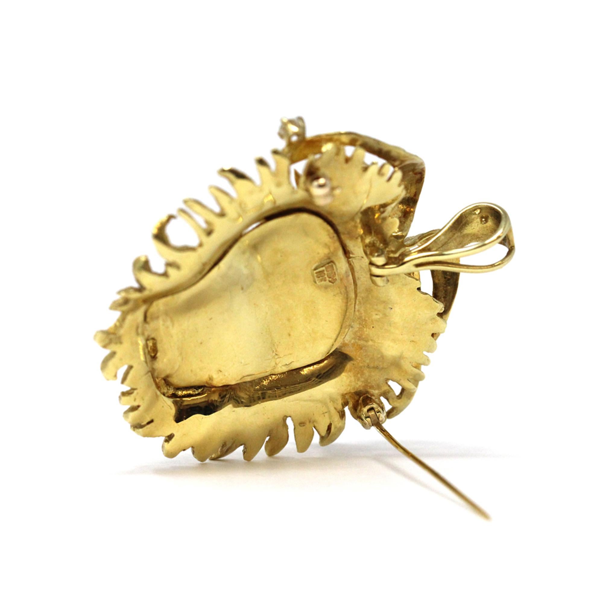 A Modern pendant/brooch lion head, circa 1960. The very well made hand executed lion head can be worn either as a pendant or as a brooch, it's made in 18k yellow and features 3 round full cut diamonds prong set. The piece measures 2 inches from bail