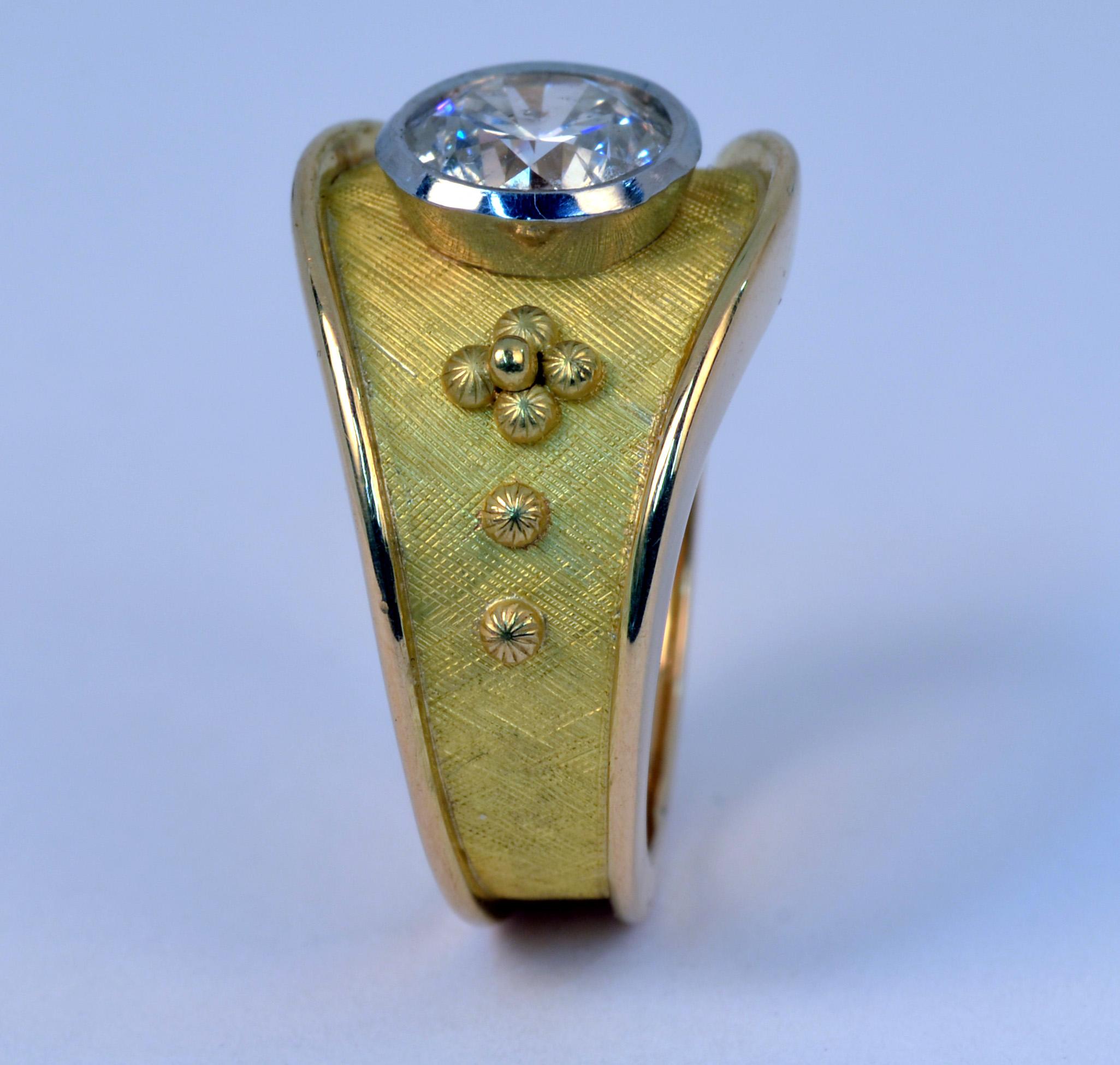 Handmade 18 Karat yellow gold and Platinum bezel set Diamond ring featuring a 1.56 round brilliant cut Diamond, G-H color and SI1 clarity. This piece is part of my Cigar Band series of rings, each one is  handcrafted and a one-of-kind creation. They