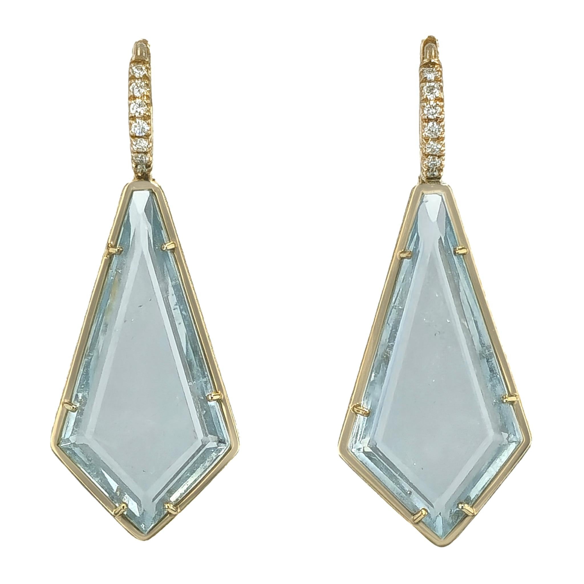 These exquisitely handcrafted drop earrings feature a total of 18.80 carats of table cut kite blue topaz set in 18 karat yellow gold. 
There is an additional 14 pieces of 0.10 total carats of F/G VS1 diamonds set in pave. 

These elegant earrings