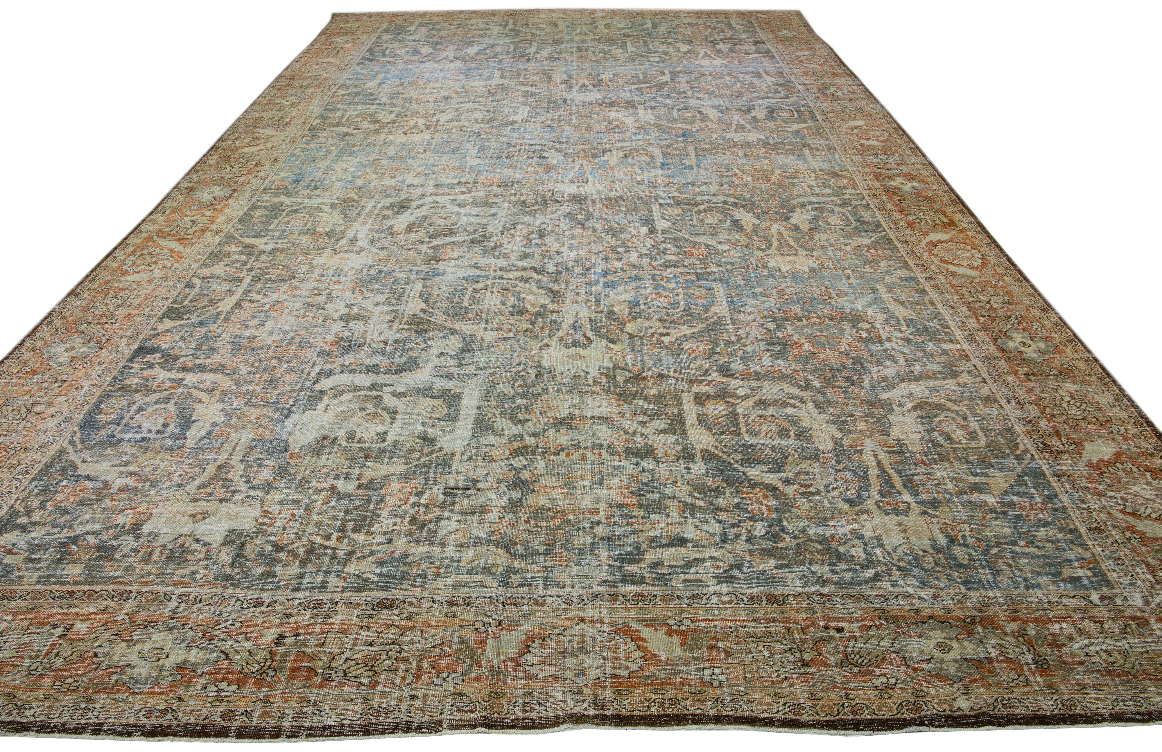 A stunning antique mahal wool rug, exquisitely hand knotted and endowed with a mesmerizing blue-gray color field. This Persian masterpiece showcases a terracotta-designed frame and beige accents that encases an all-over floral pattern.

This rug