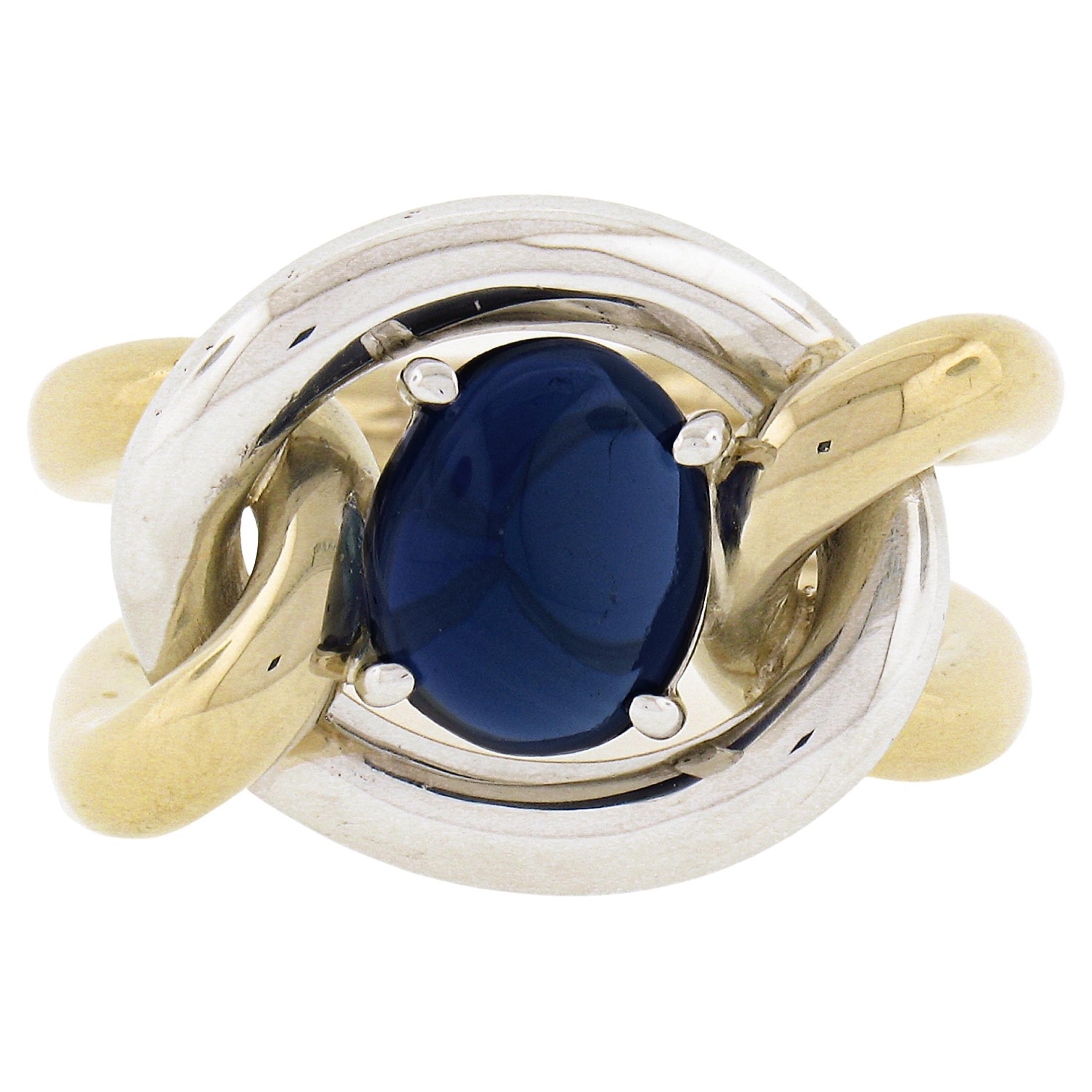 Handmade 18K TT Gold GIA No Heat Oval Cabochon Blue Sapphire Knot Cocktail Ring For Sale