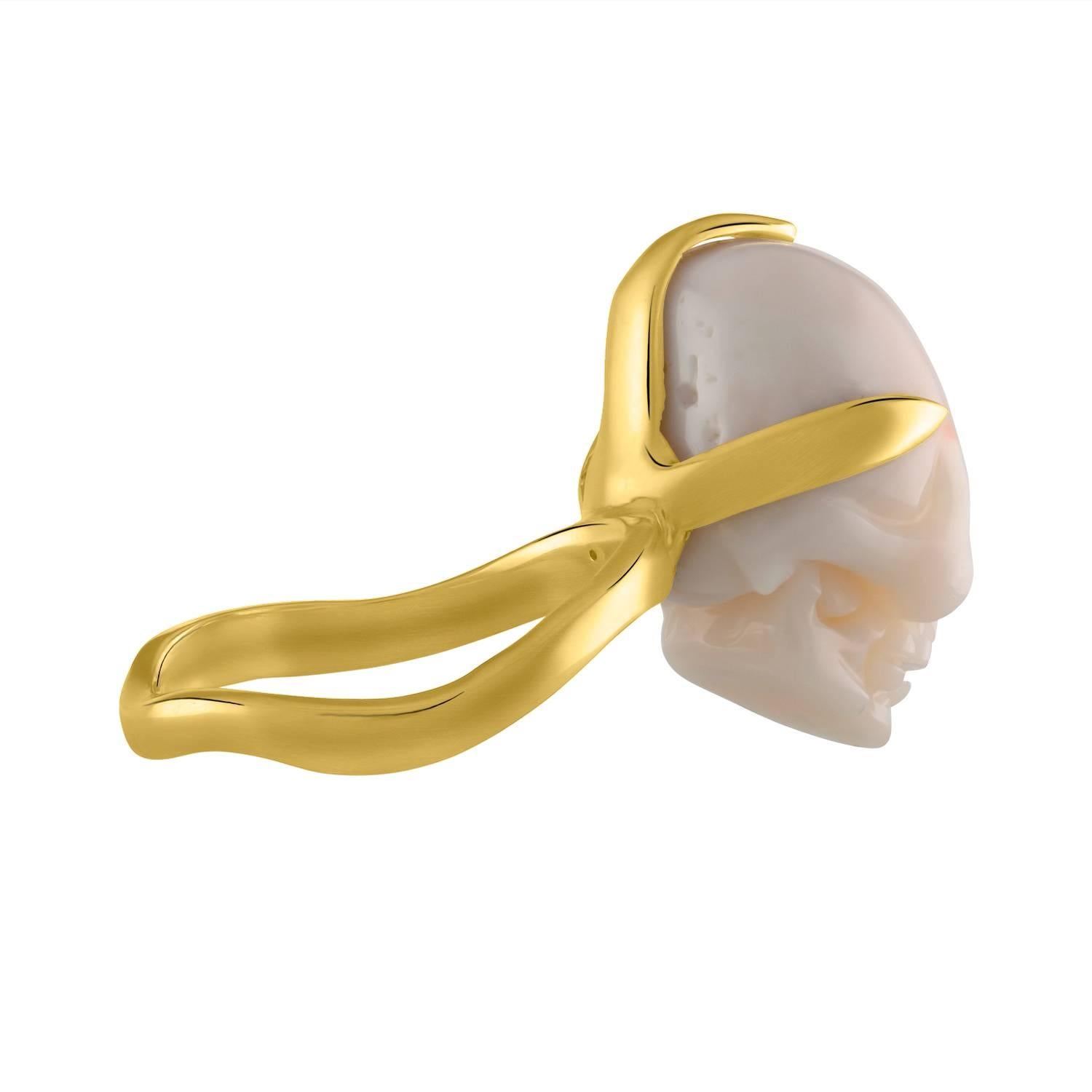 Shah & Shah handmade 18k yellow gold and hand- carved coral skull ring.

The ring is a size 6. Initial sizing is complimentary and an insurance appraisal is included with your purchase.