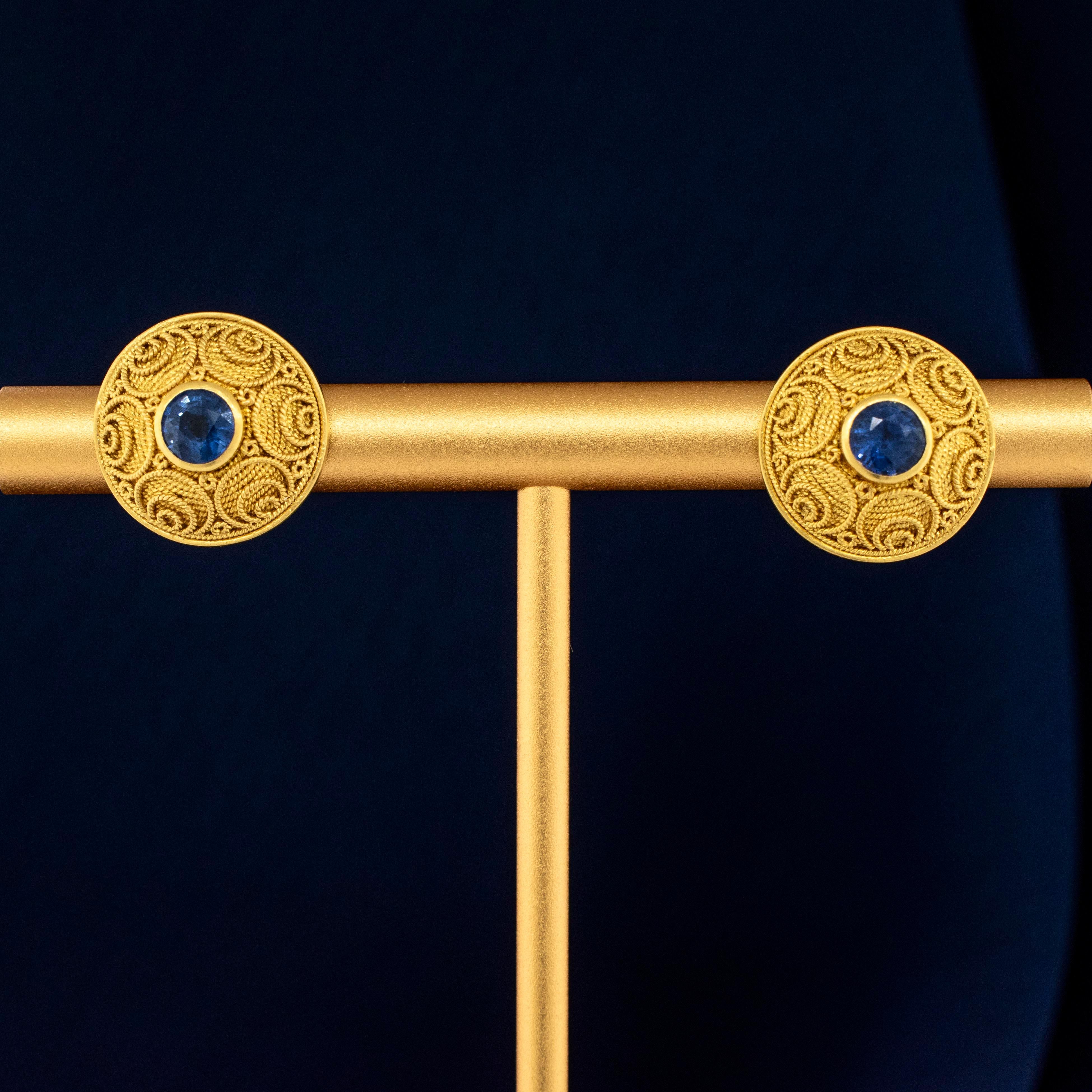 A pair of Handmade 22 Karat Yellow Gold Byzantine Style Earrings mounted with Brilliant Blue Sapphires.
The entire surface of these fabulous earrings is decorated using ancient techniques of granulation and reticulation using solid 22k gold. The