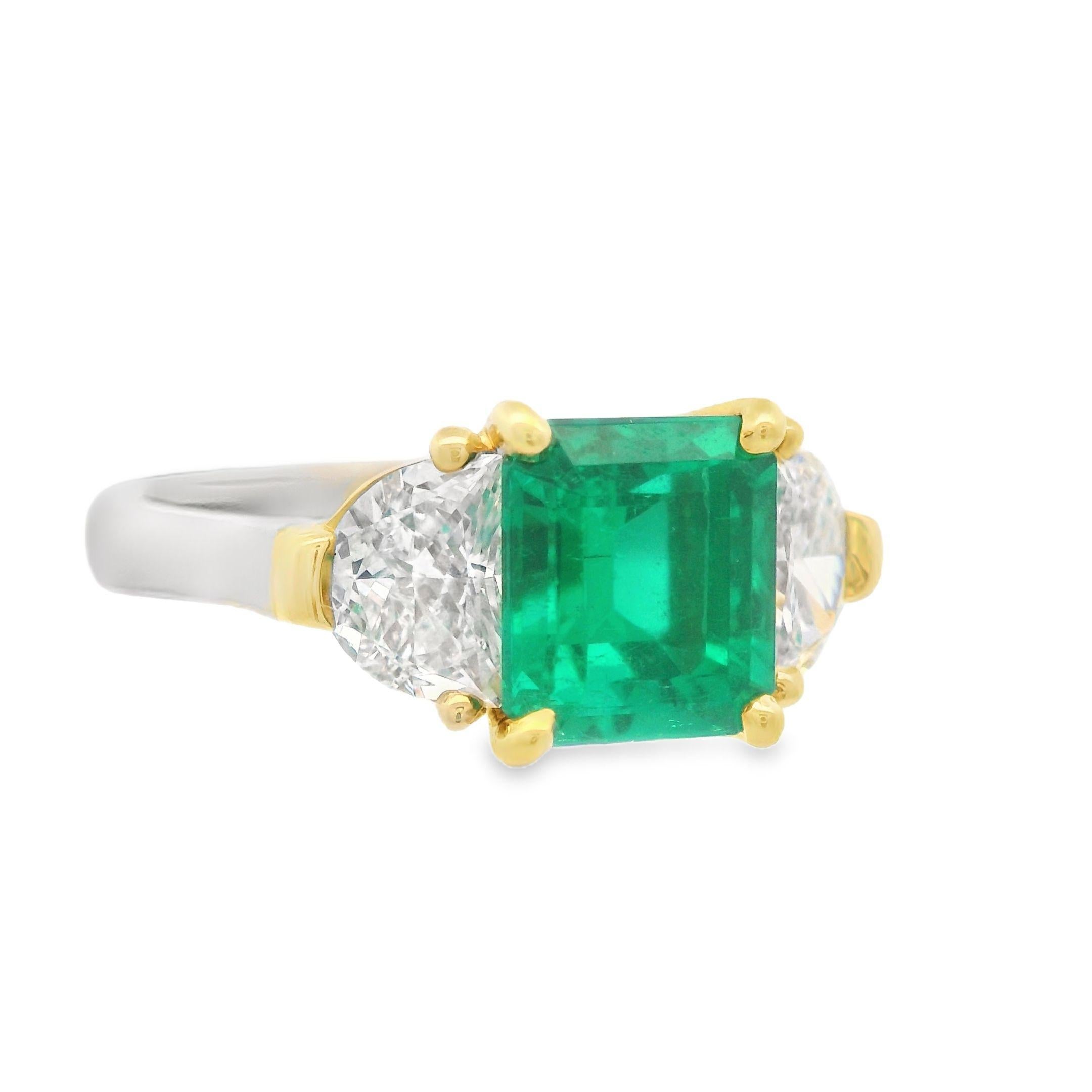 This breathtaking diamond and emerald ring was hand made in 18k buttery yellow gold and white platinum. The center stone is a square cut , 2.5 carat, vivid green emerald that catches fiery flashes of light, reflecting a dramatic green field. On each