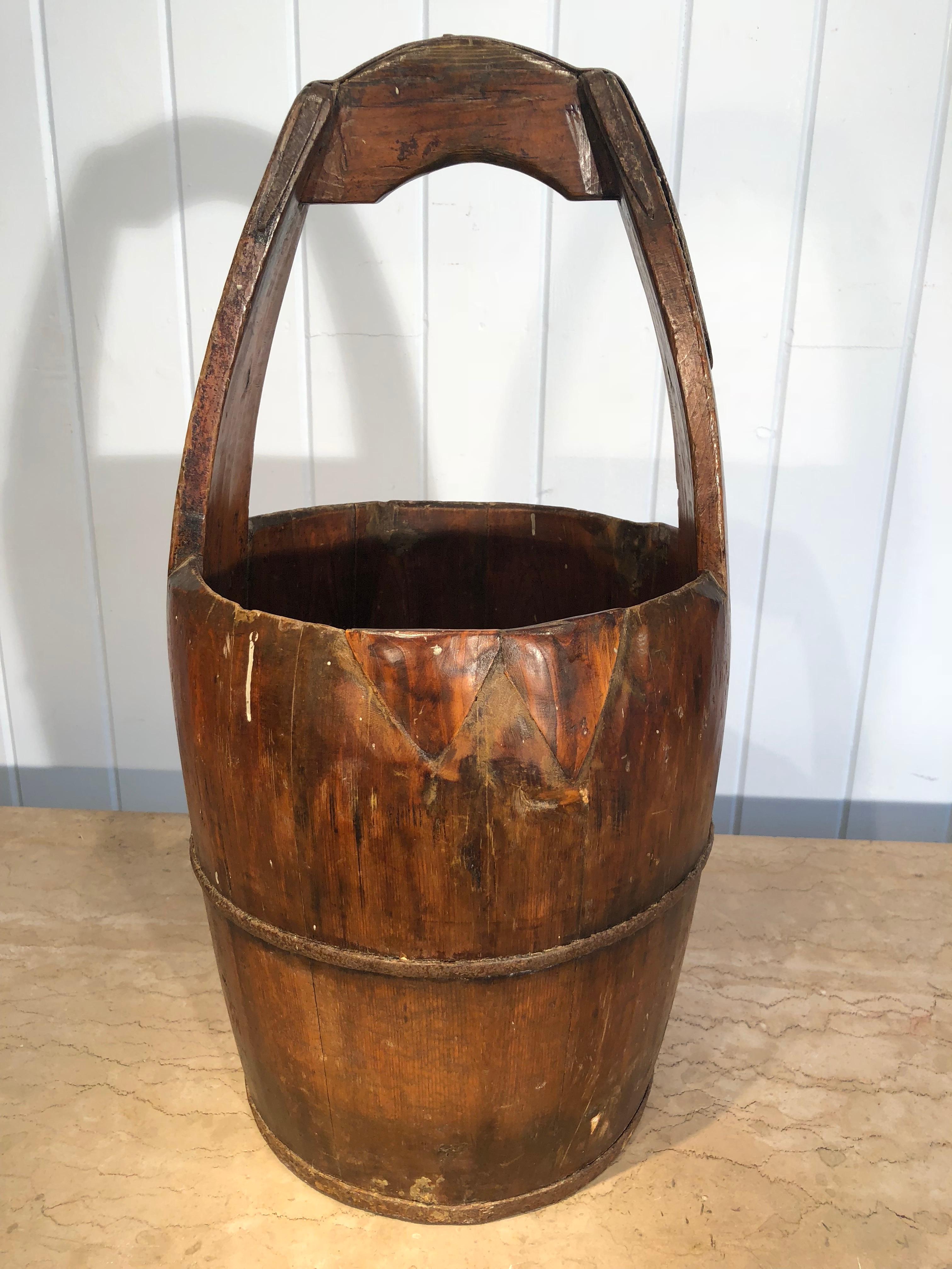 We found two of these lovely handmade oak milk buckets at our local brocante in Tournon d'Agenais, and they are beauties. We have cleaned and polished them so their deep lustrous patina shows to their best effect. They would make great decorative
