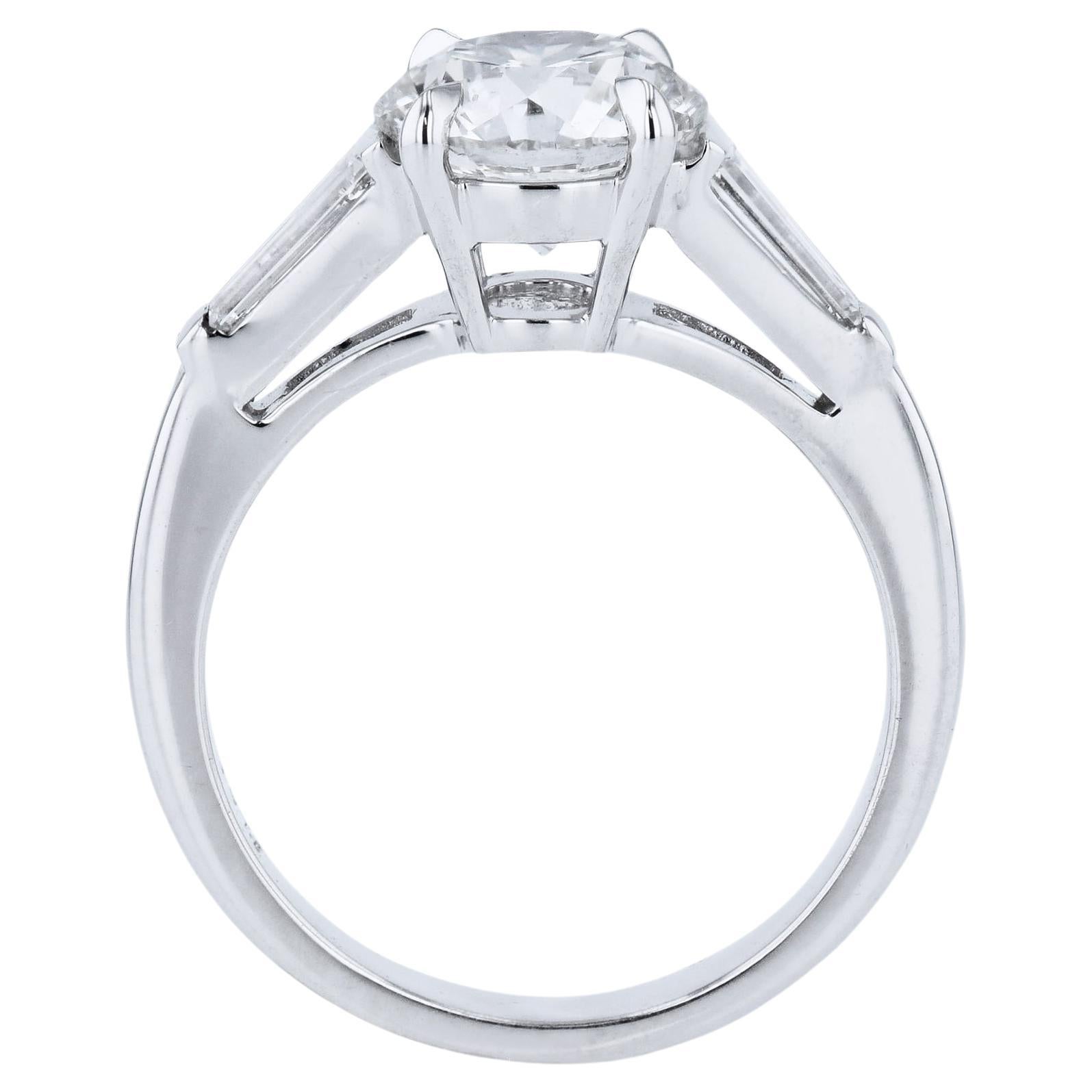 Enchanting 2.03ct Round Diamond Platinum Engagement Ring, adorned by two Baguette Diamonds. Lovingly handcrafted for the H&H Collection, this spectacular ring is sized 5.50.

Round Diamond Platinum Engagement Ring.

Platinum.

Center Diamond: 2.03ct