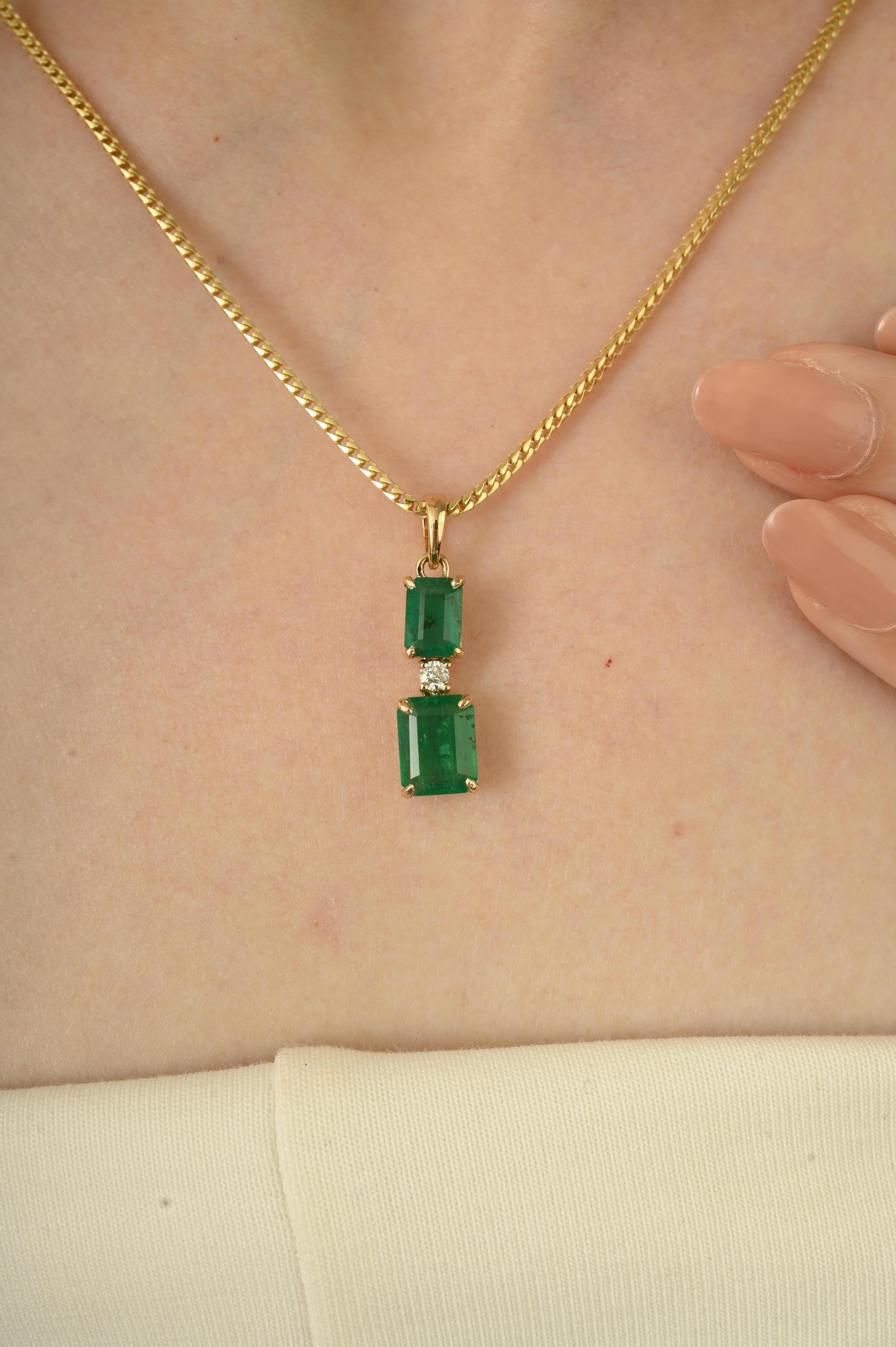 Ce pendentif Elegant est composé de deux émeraudes naturelles de taille émeraude totalisant 2,86 carats, rehaussées d'un diamant rond de taille brillant de 0,07 carat. Les pierres sont serties dans un riche or jaune 14 carats, mettant en valeur un