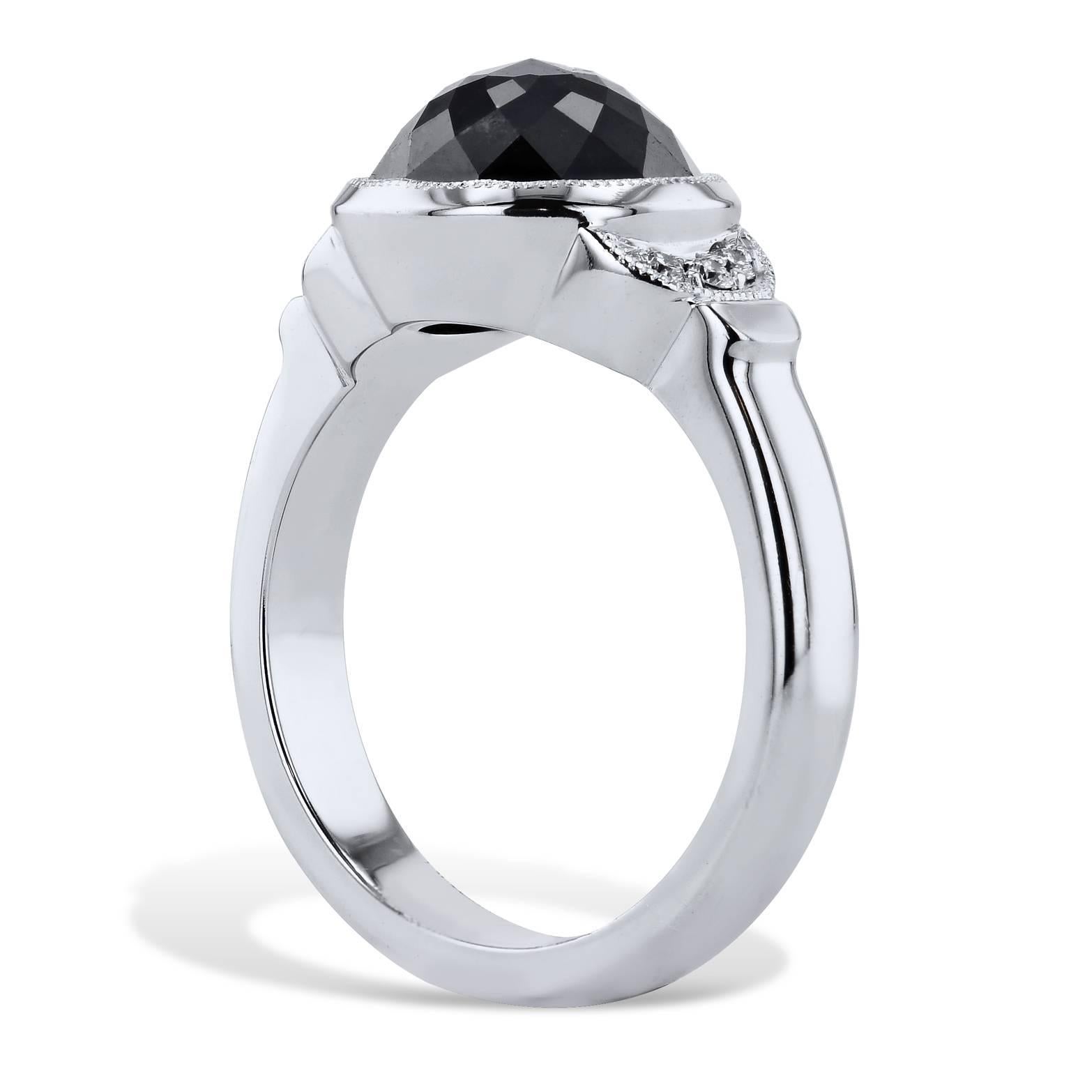 This beautiful rose cut black diamond ring is handmade and one of a kind. It features a stunning 4.00 carat rose cut black diamond that is bezel set. It also has 0.06 carats of pave diamonds that are set in a crescent moon shape. These white
