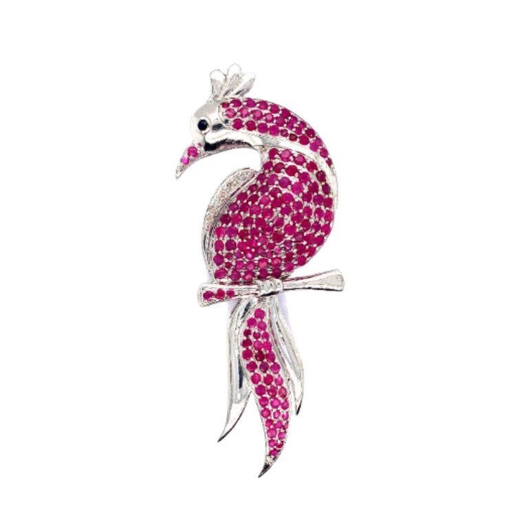 Introducing Ruby Peacock Brooch Made in Sterling Silver which is a fusion of surrealism and pop-art, designed to make a bold statement. Crafted with love and attention to detail, this features 5.83 carats of ruby which makes you stand out of the