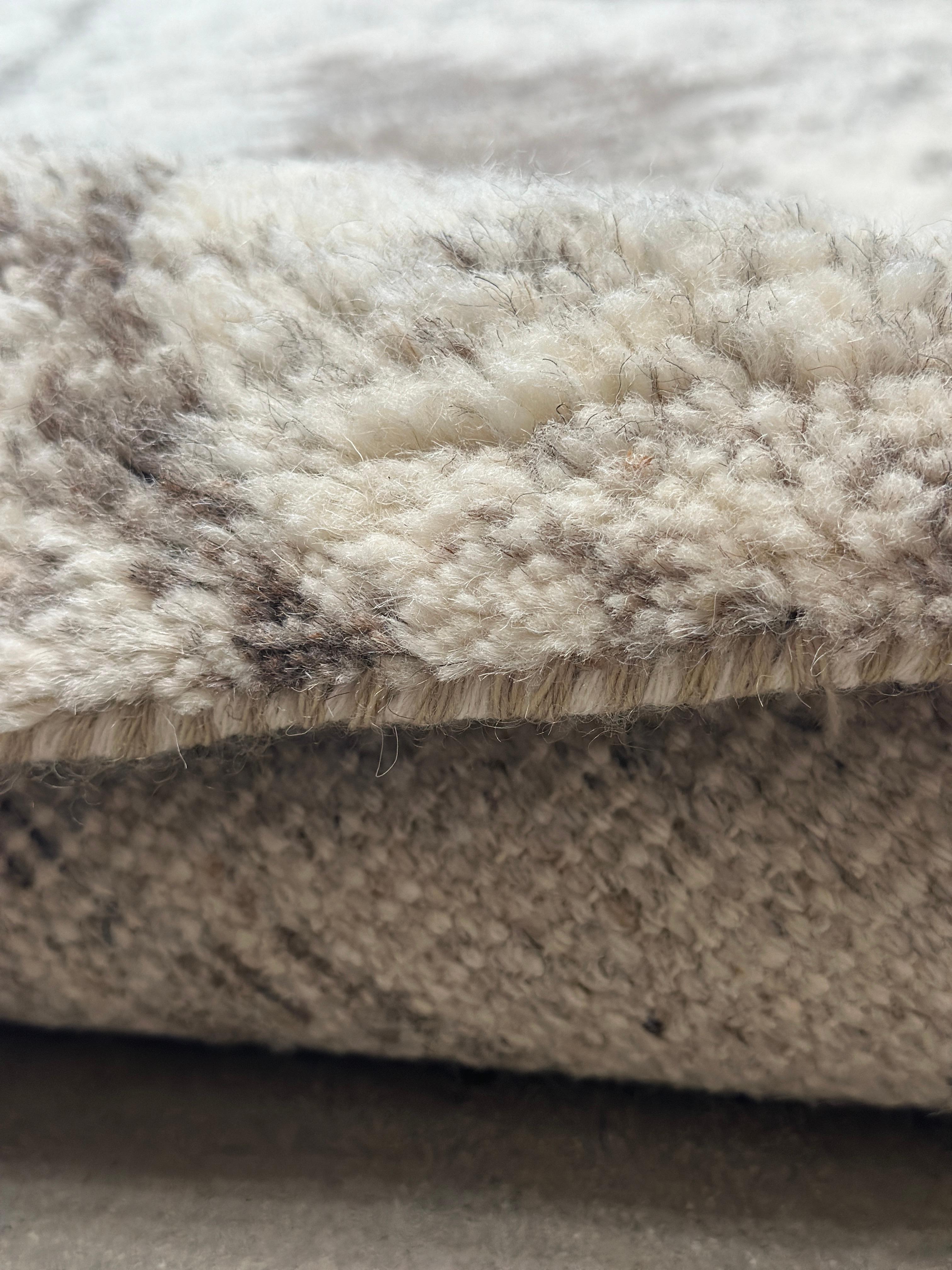 Elevate your home décor with the Plush Moroccan Rug, showcasing a mesmerizing concentric diamond pattern. This luxurious rug effortlessly blends traditional Moroccan artistry with contemporary design, featuring a harmonious palette of beige and