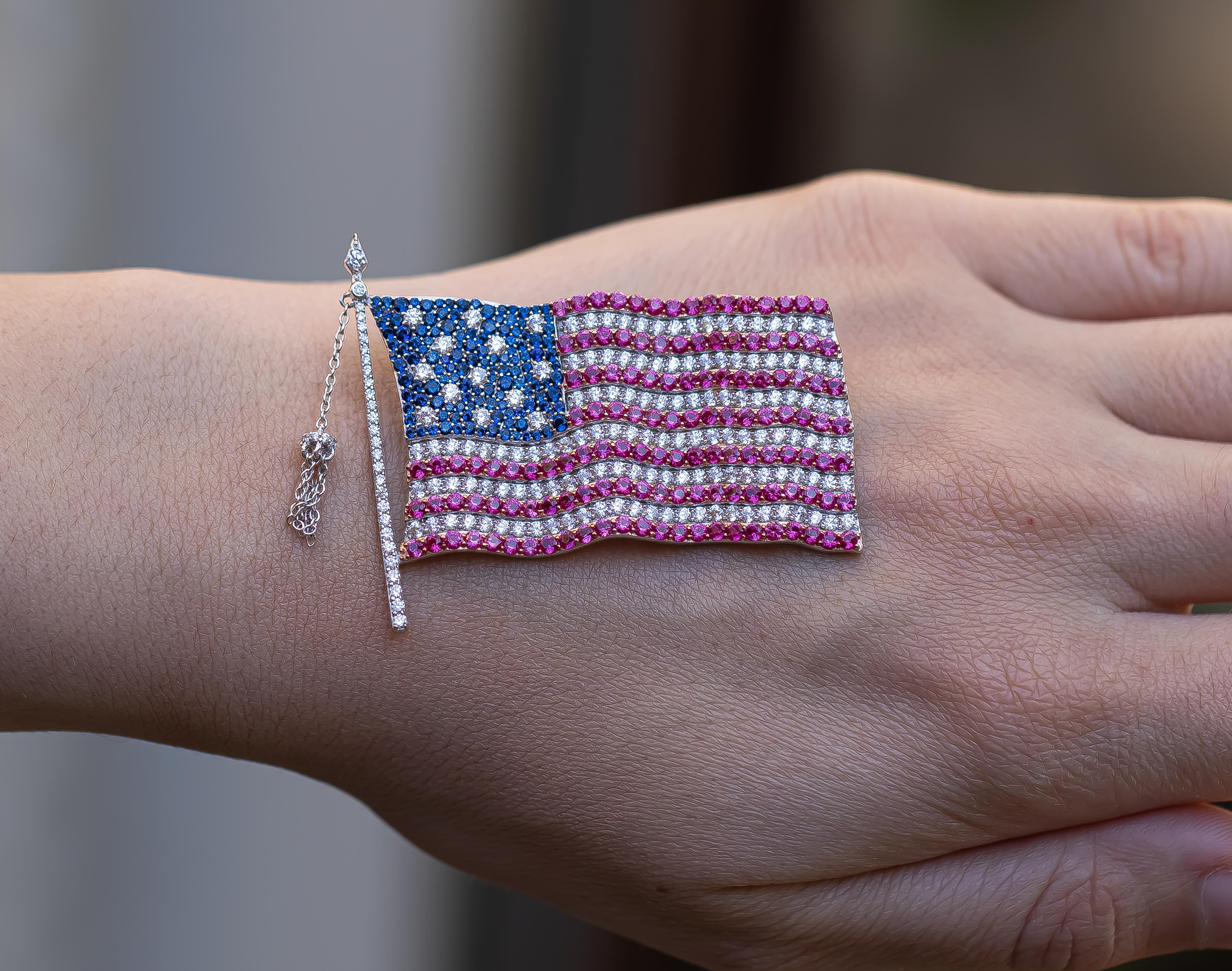 Hand Made Flag Brooch Set with Cubic Zirconia 
Gem Set: AAA Grade Pink Blue & White Cubic Zirconia
Metal: Rhodium on Sterling Silver
Style: Modern 