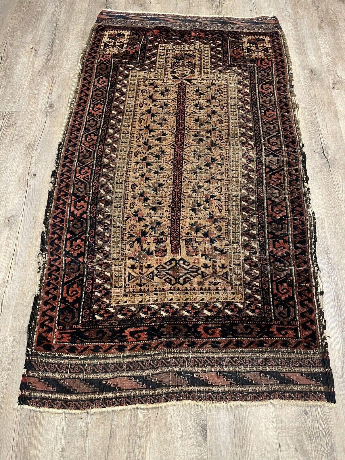 Enhance your space with the timeless charm of this Handmade Antique Afghan Baluch Collectible Rug, dating back to the late 19th century. Crafted with care by skilled artisans in Afghanistan, this exquisite rug showcases the intricate artistry and