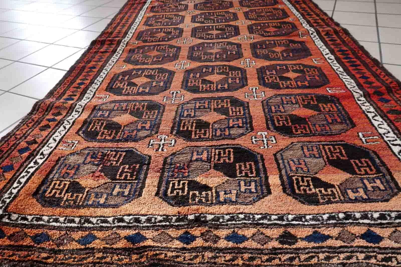 Handmade antique Afghan Baluch rug in repeating pattern. The rug is from the beginning of 20th century in original condition, it has some low pile.

-condition: original, some low pile,

-circa: 1900s,

-size: 3.7' x 6.6' (114cm x