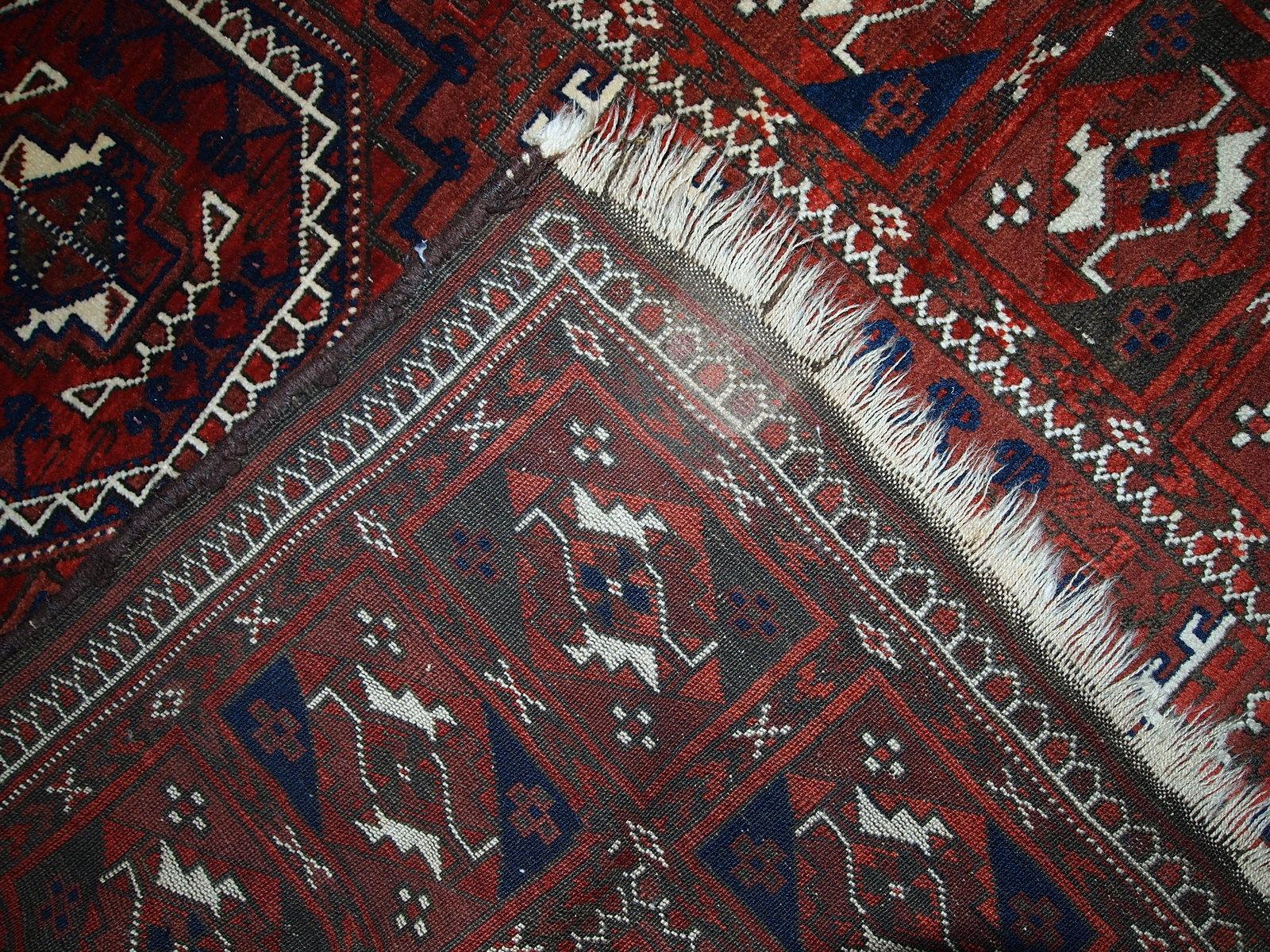 Antique hand made Afghan Baluch rug in original condition, has some age wear. The rug is in traditional deep burgundy shade with navy blue and white accents, has very rich combination of colors. 

-Condition: original, some age wear,

-Circa: