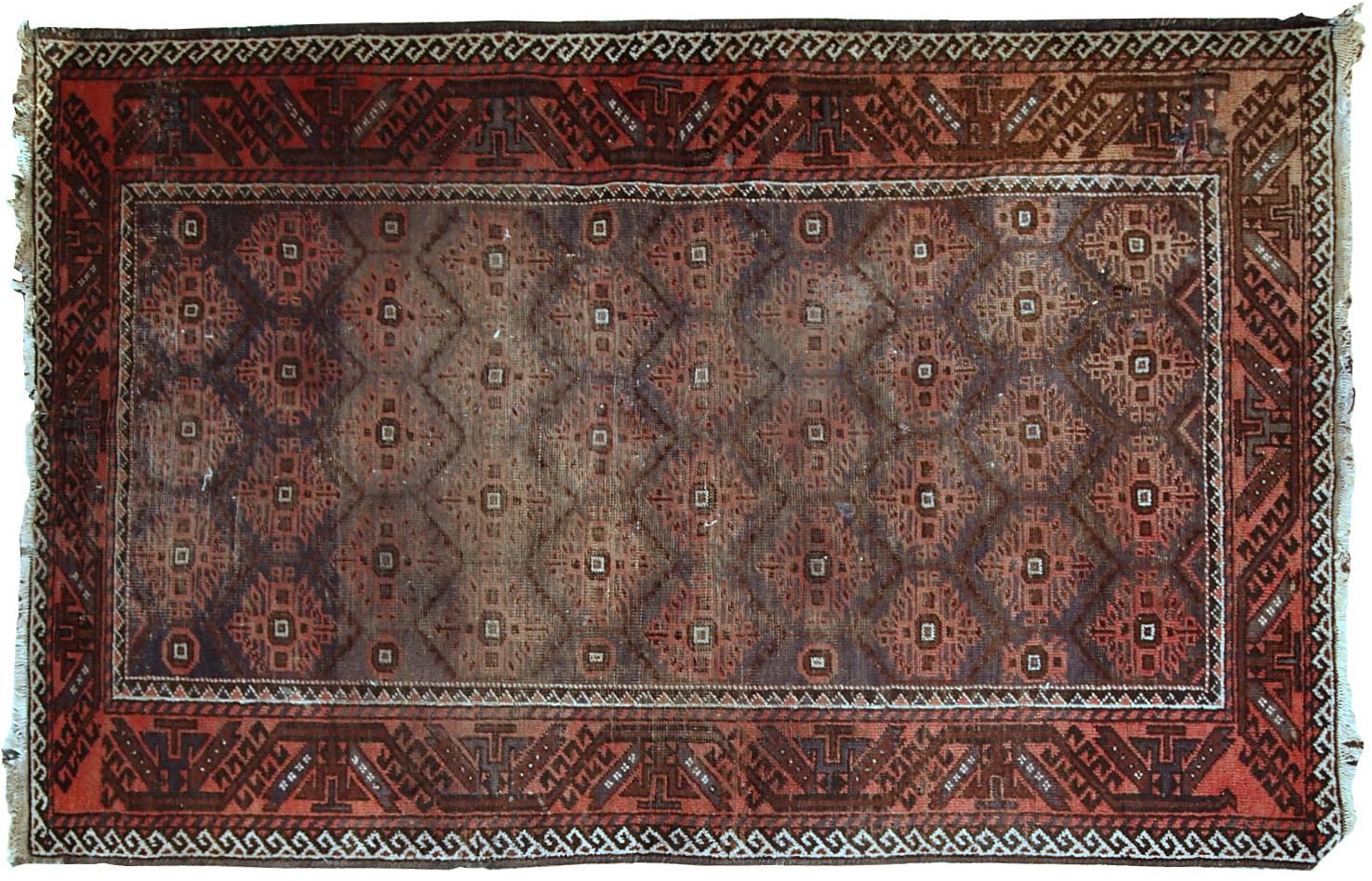 Distressed Afghan Baluch rug from the beginning of 20th century in original condition. All-over design in burgundy, pink and dirty blue shades. The rug has no holes.
 