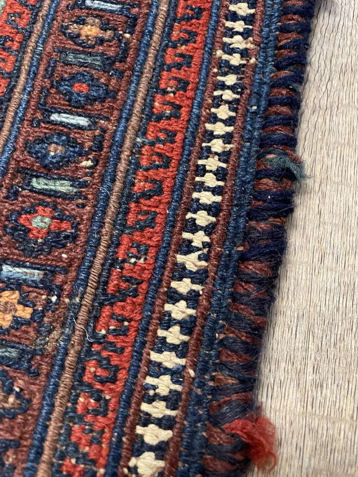 Uncover the rich heritage of Afghan craftsmanship with this antique Sumak wool rug, a remarkable creation from the 1920s. Measuring 109 cm x 146 cm (3.6 ft x 4.8 ft), this handmade piece showcases the intricate flatweave technique distinctive to
