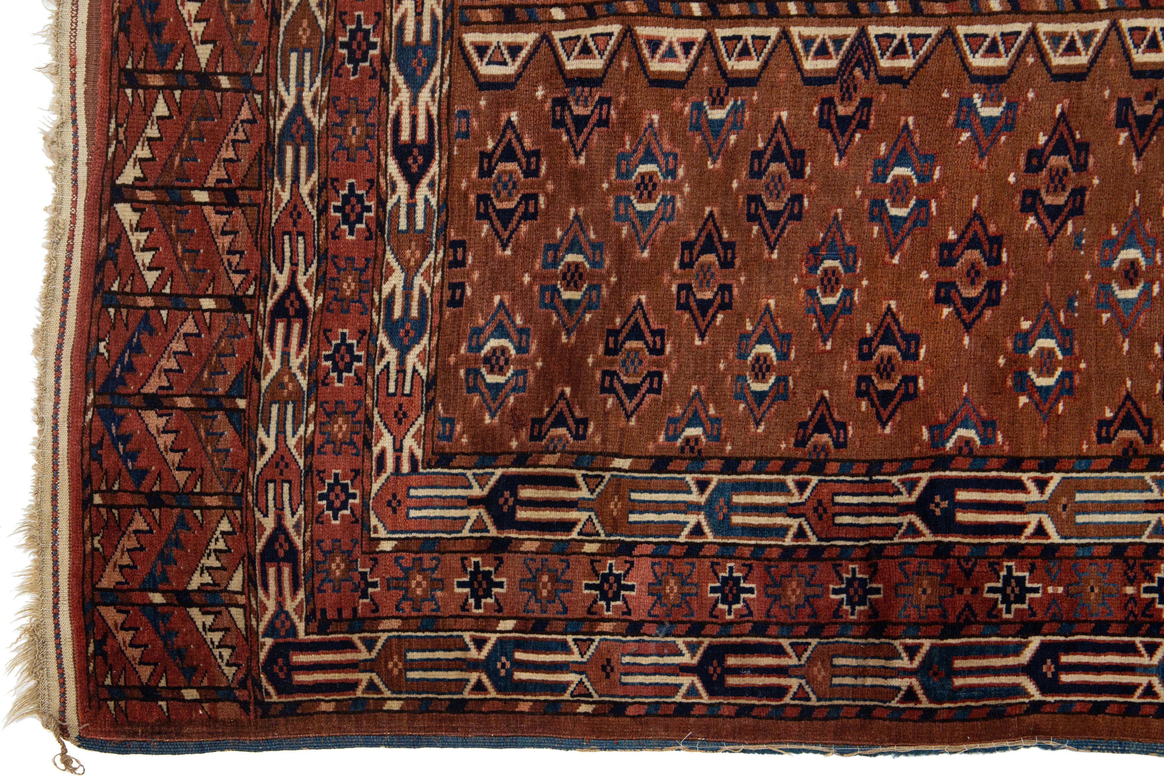 Early 20th Century Handmade Antique Afghan Yamoud Wool Rug In Brown With Allover Pattern  For Sale