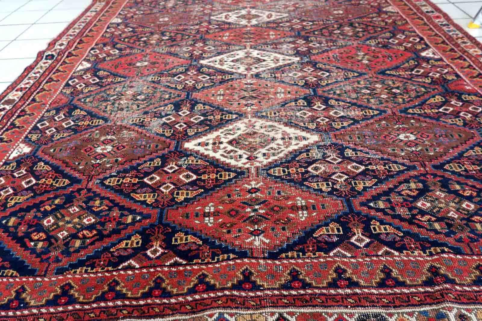 Handmade antique rug from Afshar region. The rug is from the beginning of 20th century in distressed condition.

-condition: distressed,

-circa: 1910s,

-size: 5.5' x 6.8' (170cm x 208cm),

-material: wool,

-country of origin: Middle
