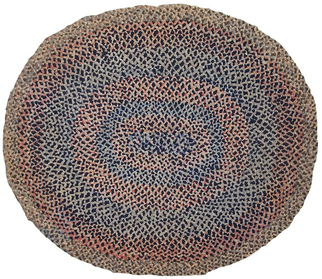 Antique American Braided handmade oval rug in original good condition. It is made out of cotton stripes in different shades of blue and red. Very charming rug of American craft.
 