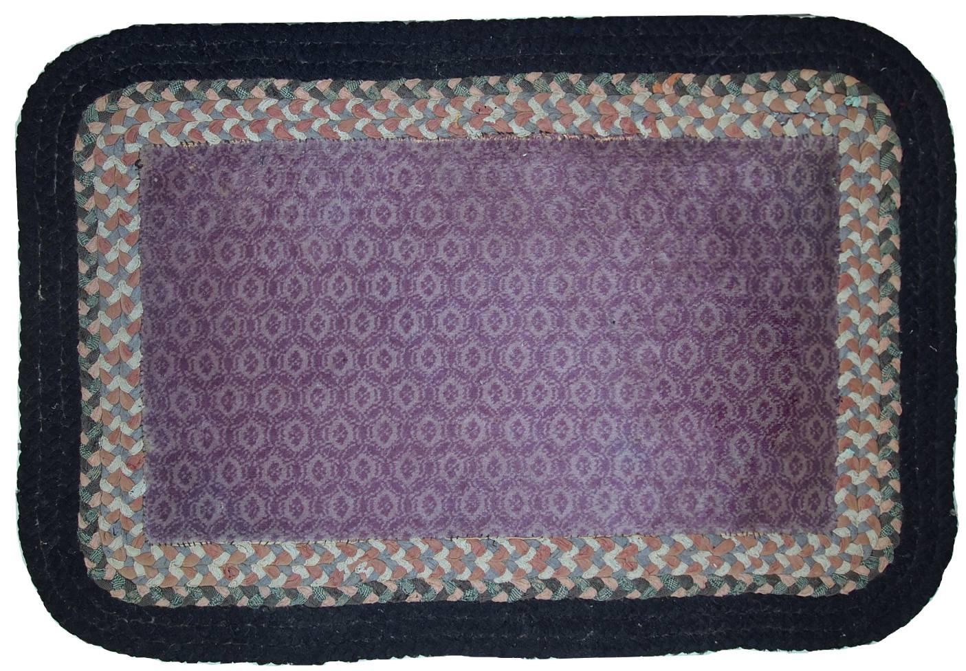 Handmade antique American braided unusual rug. The central part is made out of purple fabric and it has been attached to a cotton Braided border. The rug is in original condition, it has some traces of age. 

 
