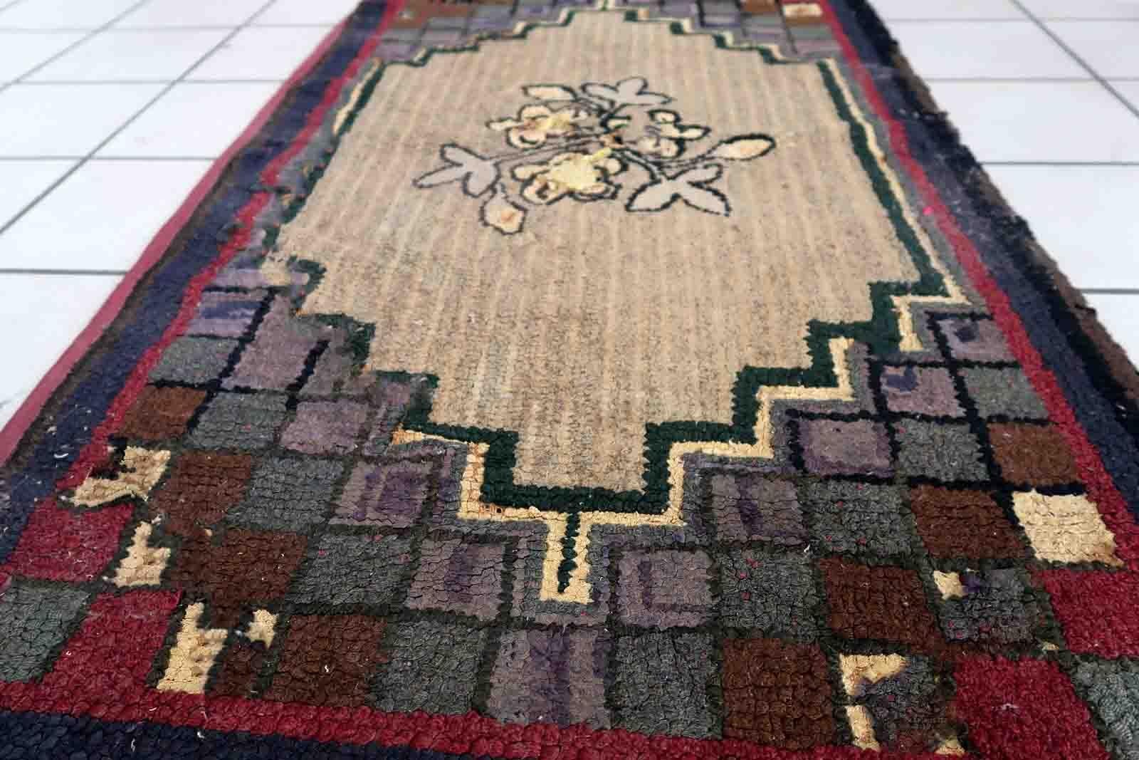 Handmade antique American Hooked rug in floral design. The rug is from the end of 19th century in good condition, the rug has old restorations.

-condition: good, restored,

-circa: 1880s,

-size: 2.1' x 4' (67cm x 122cm),

-material: