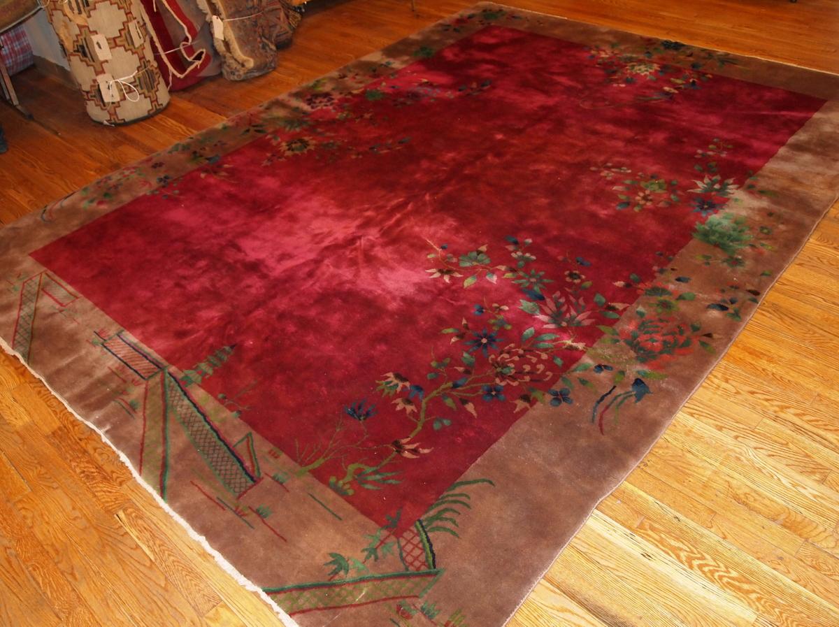 Beautiful antique Art Deco Chinese rug in original condition. It is in fuchsia colour with floral accent around the mocha border. The rug has a full pile and in excellent original condition. 

-condition: original good,

-circa: 1920s,

-size: