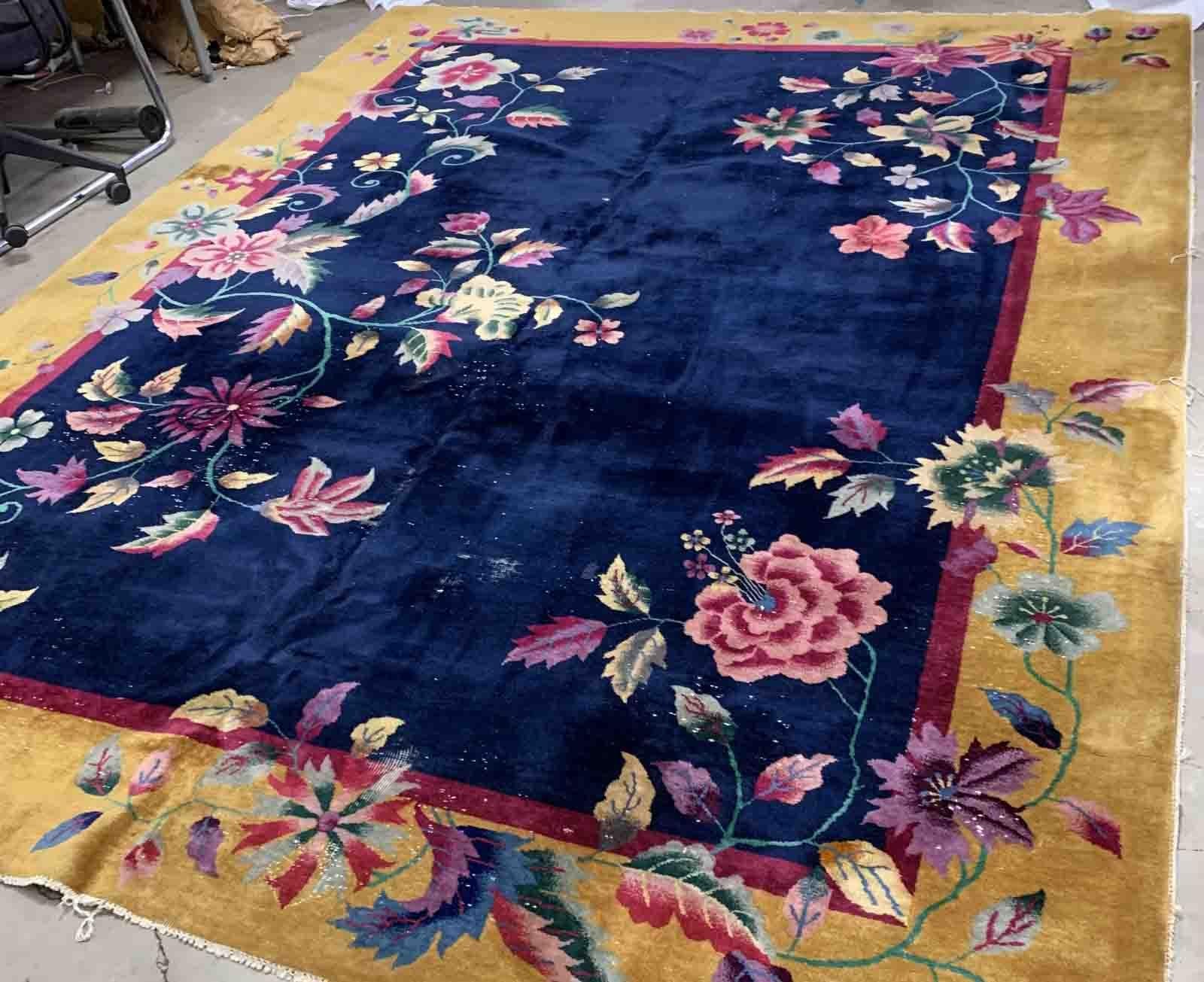 Handmade antique Art Deco Chinese rug in navy blue and golden shades. The rug is from the beginning of 20th century in original condition, it has some low pile. 

-condition: original, some low pile,

-circa: 1920s,

-size: 9.1' x 11.6' (277cm