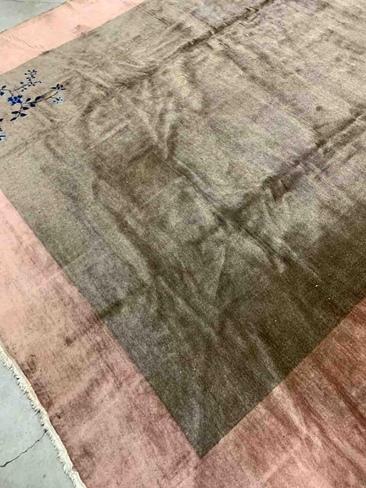 Handmade antique Art Deco Chinese rug in olive green and peach shades. The rug is from the beginning of 20th century in original condition, it has some low pile. 

-condition: original, some low pile,

-circa: 1920s,

-size: 8.10' x 11.6'