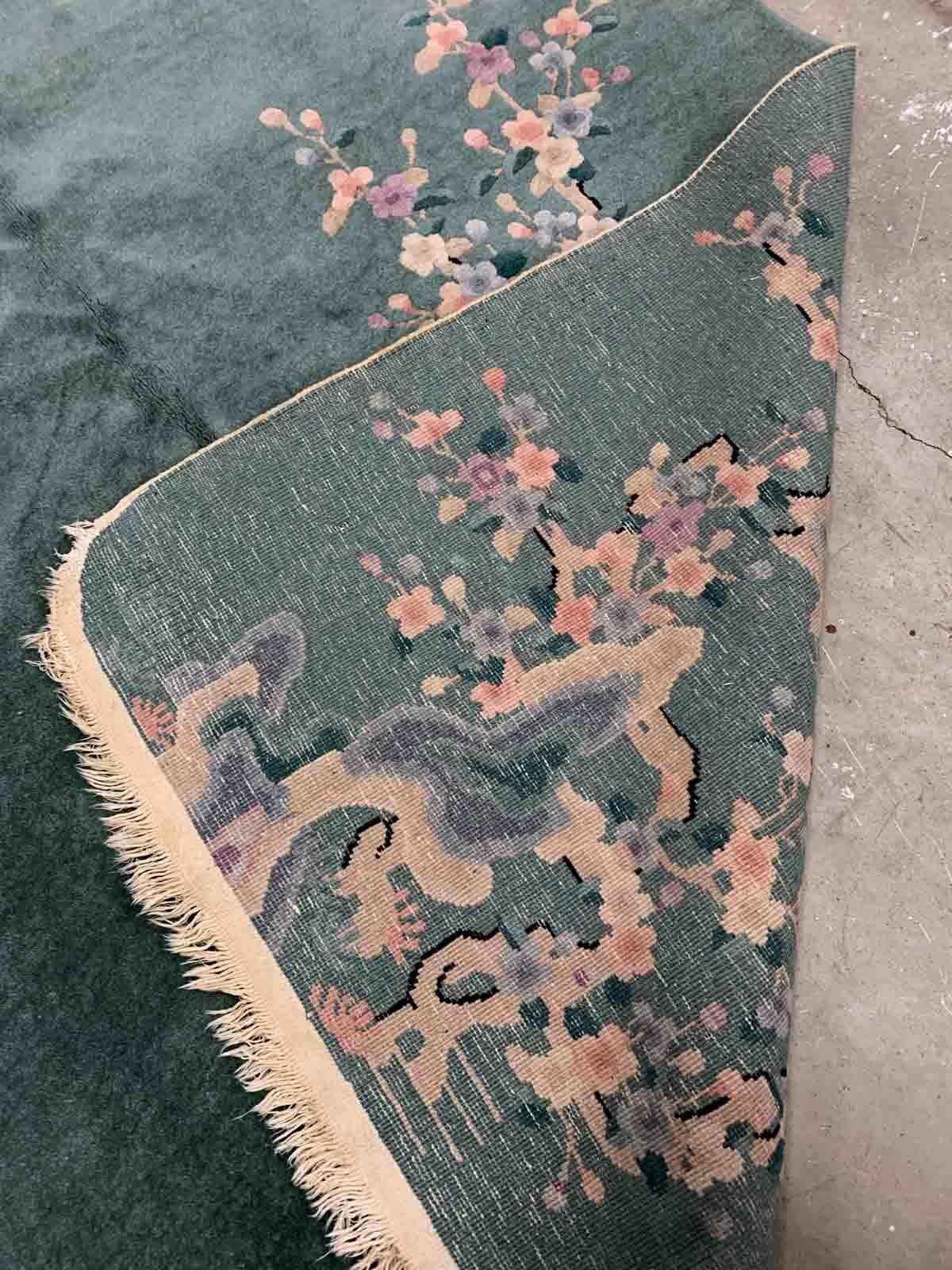 Handmade antique Art Deco Chinese rug in green shade with floral design. The rug is from the beginning of 20th century in original good condition. 

-condition: original good, 

-circa: 1920s,

-size: 5.1' x 8.2' (155cm x