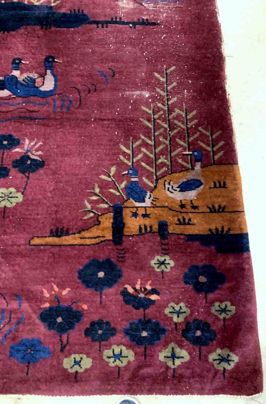 Handmade antique Art Deco Chinese rug in burgundy color with some ducks design. The rug is from the beginning of 20th century in original condition, it has some low pile.

-condition: original, some low pile,

-circa: 1920s,

-size: 4.1' x