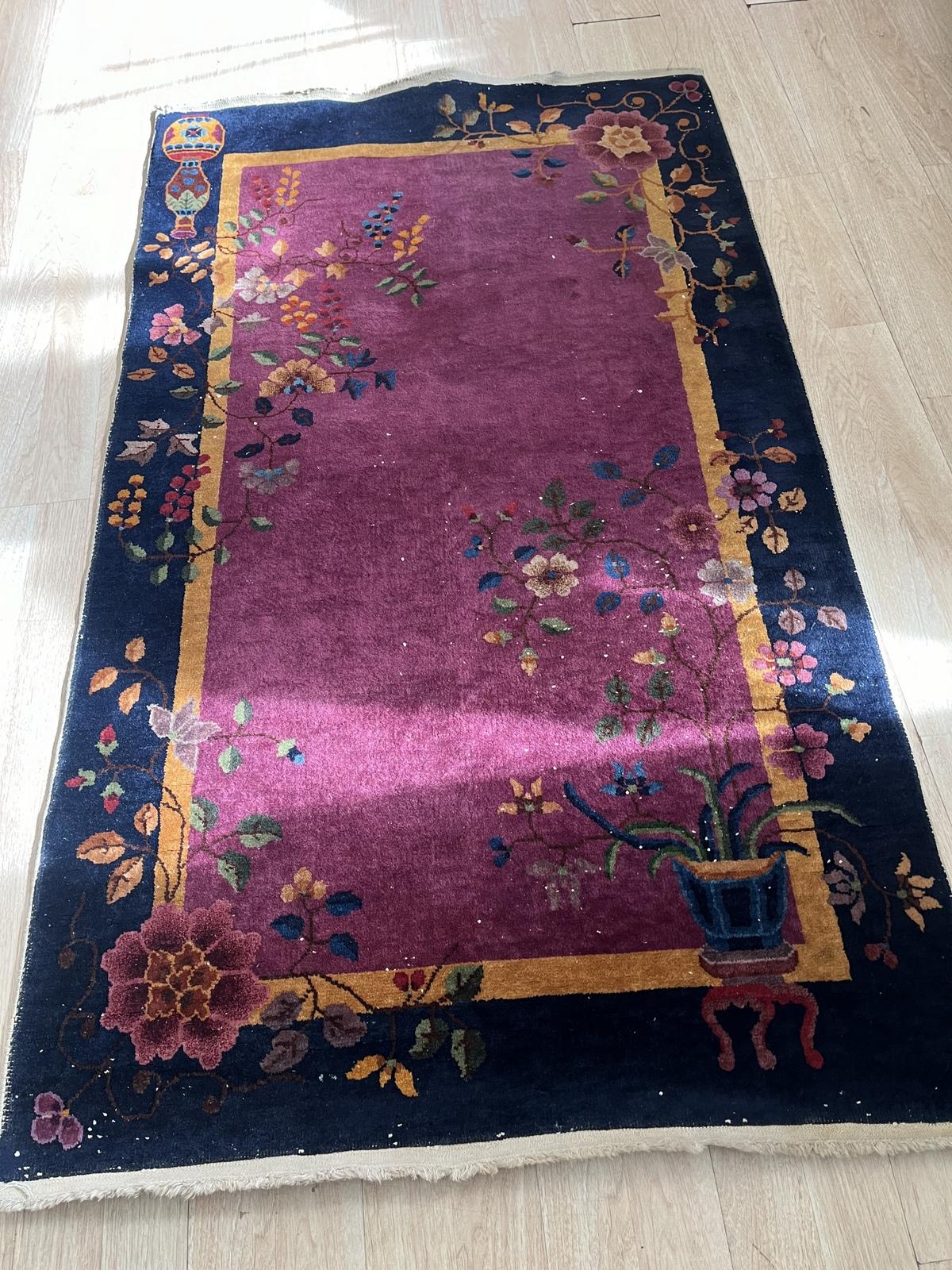 This handmade antique Art Deco Chinese rug from the 1920s is a stunning example of traditional craftsmanship. Measuring 4 feet (122 cm) in width and 7 feet (213 cm) in length, this beautiful wool rug is in good condition overall, with some areas of