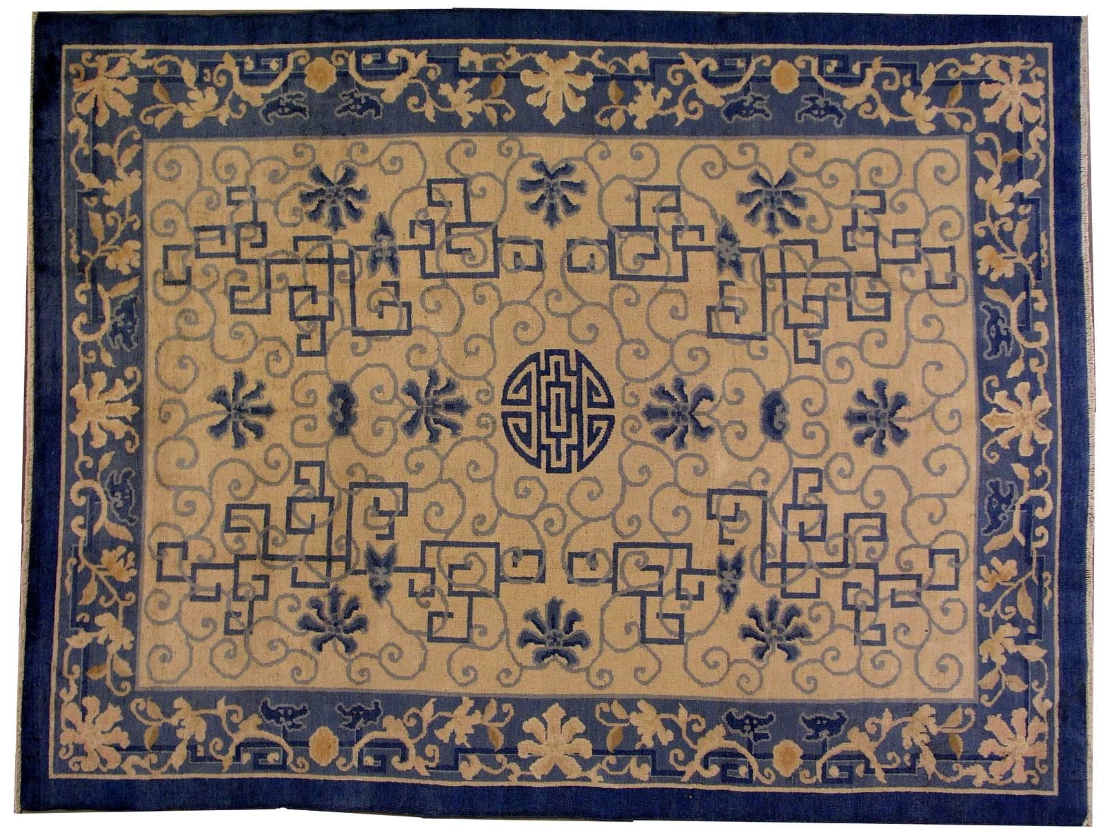 Antique Peking Chinese rug in good condition. The rug has very unusual design for typical Peking rugs. Geometric figures in blue shade are randomly attached to a beige background. The very nice light blue border is around it. The rug is in original