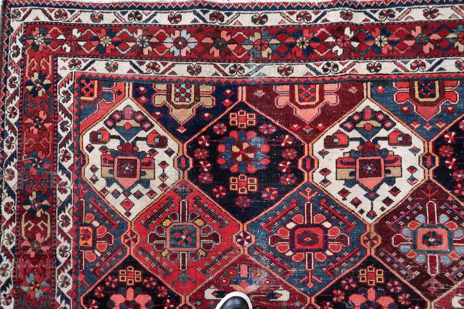 Handmade antique Bakhtiari rug in traditional garden design with diamonds. The rug is from the beginning of 20th century in original condition, it has some low pile.

-condition: original, some low pile,

-circa: 1930s,

-size: 7.3' x 9.8'