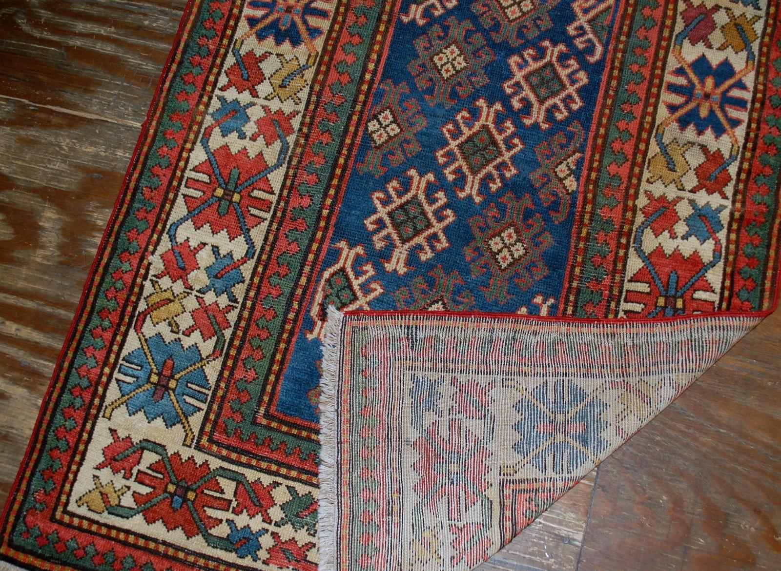 Antique handmade Caucasian Gendje rug in good condition. The rug is from the end of 19th century, made in Russia.

- Condition: good,

- circa 1880s,

- Size: 3.2' x 8' (97cm x 244cm),

- Material: wool,

- Country of origin: Russia,

-