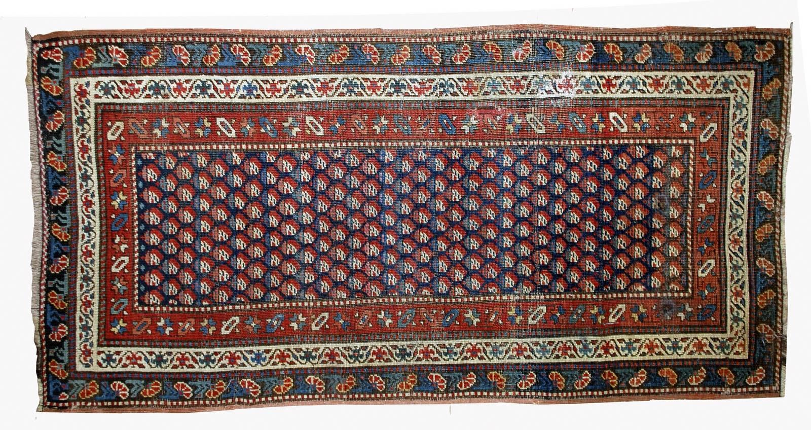 Antique handmade Caucasian Gendje rug in original condition. The rug has navy blue border and all over deign in red shades. It also has tripple border in red, beige and azure colors. Beautiful combination of shades. The condition is original good,