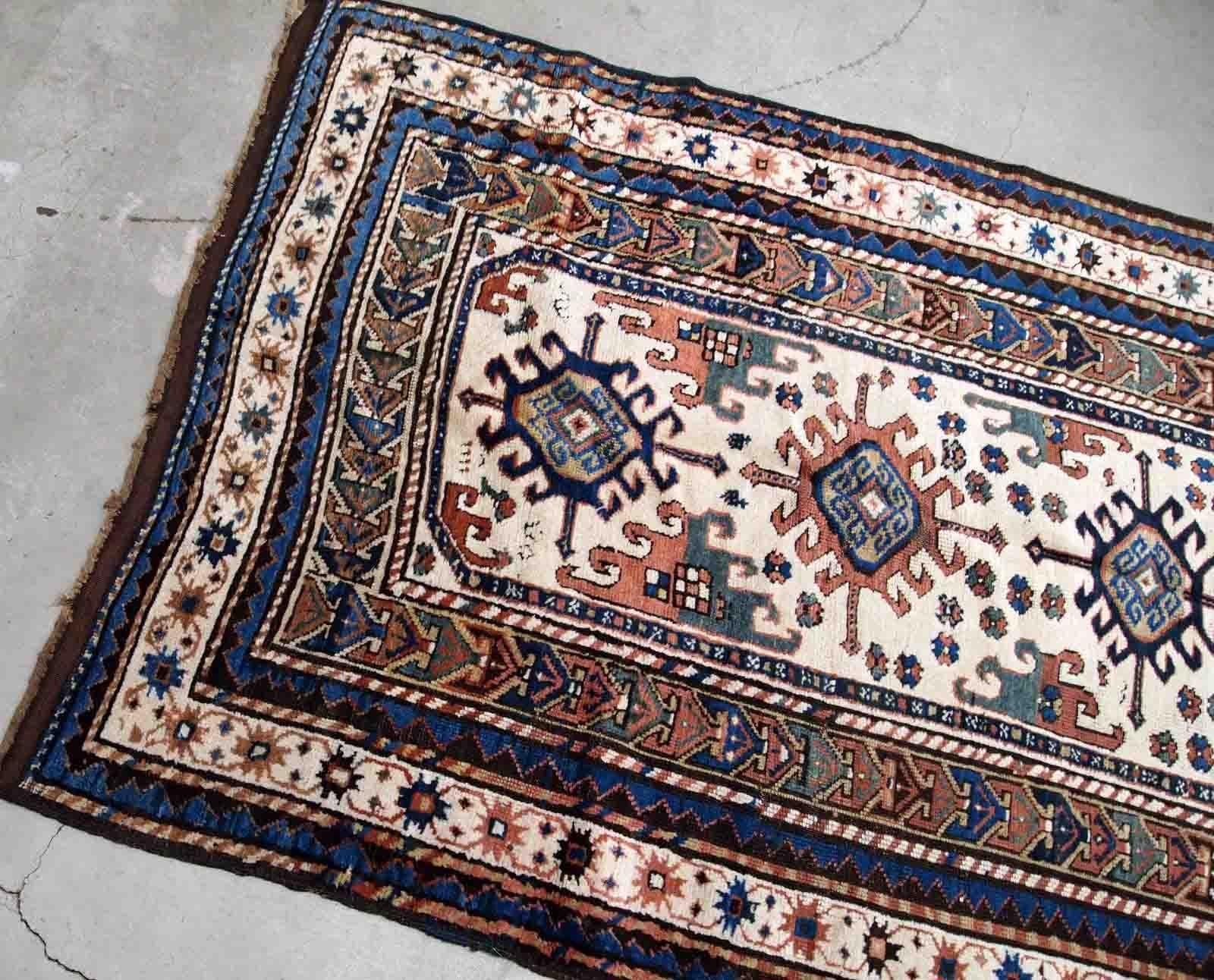 Handmade antique Caucasian Kazak rug in kele size. The rug is from the end of 19th century in original good condition.

-condition: original good,

-circa: 1870s,

-size: 4.2' x 8.7' (128cm x 265cm),
?
-material: wool,

-country of origin: