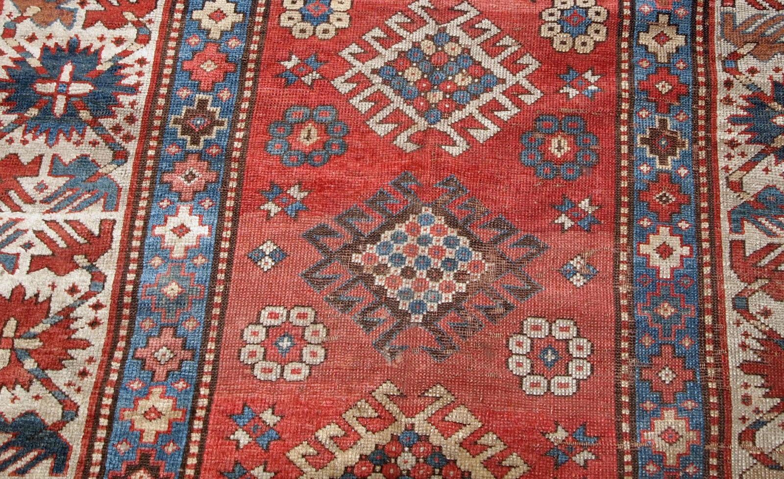 Handmade antique Caucasian Kazak rug in red and beige shades. The rug is from the end of 19th century in original condition, it has some low pile, a little cut on one side.

-condition: original, low pile, a little cut on one side,

-circa: