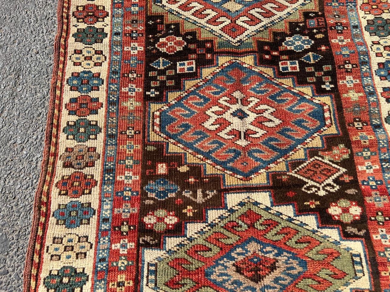 A magnificent example of a late 19th-century Caucasian Kazak rug, hand-knotted with exceptional artistry in the 1880s. This antique masterpiece showcases the bold, geometric motifs that are characteristic of the region. The central design features