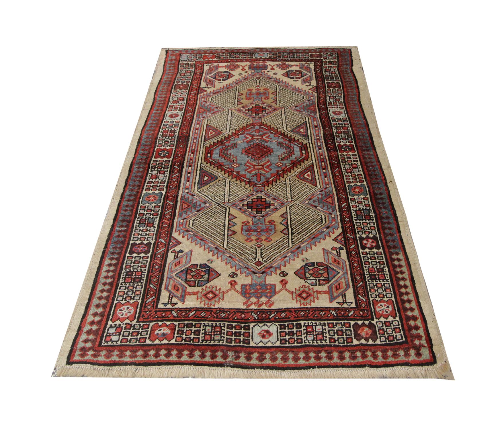 Handmade in the 1940s this highly detailed area rug features a tribal geometric design. The multi-layered border reveals a repeat pattern which encompasses the central design. In the central motif is a stylised pool woven in blue which contrasts