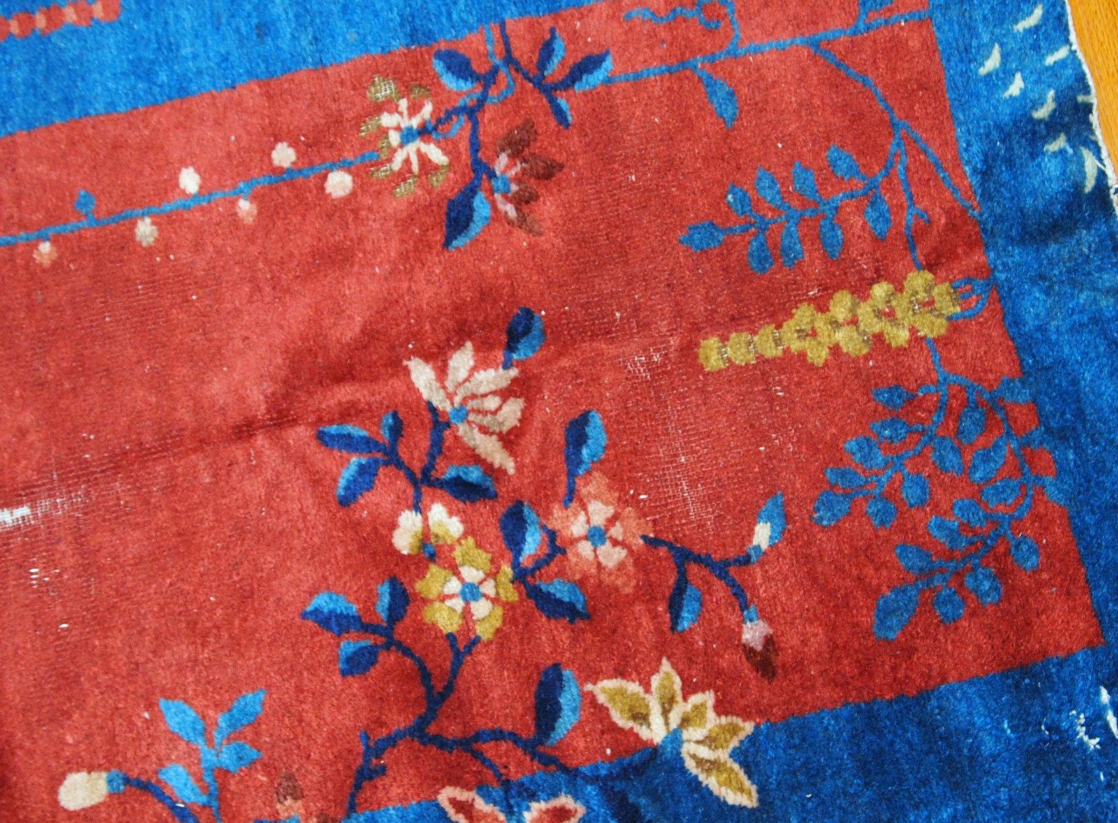 Handmade antique Art Deco Chinese rug from the beginning of 20th century in red and blue wool. The rug is in original condition, it has some low pile.

- Condition: Original, some low pile,

- circa 1920s,

- Size: 2.3' x 4.2' (71 cm x 129