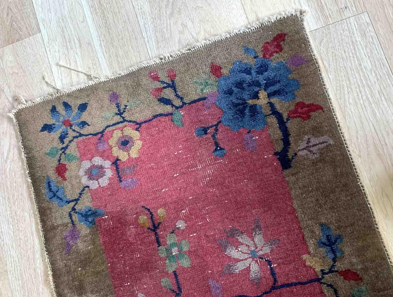 This exquisite Art Deco Chinese rug from the 1920s is a true masterpiece of craftsmanship. It is entirely handmade with meticulous attention to detail, using high-quality wool as the primary material. The rug measures 2.1 feet in width and 4.2 feet