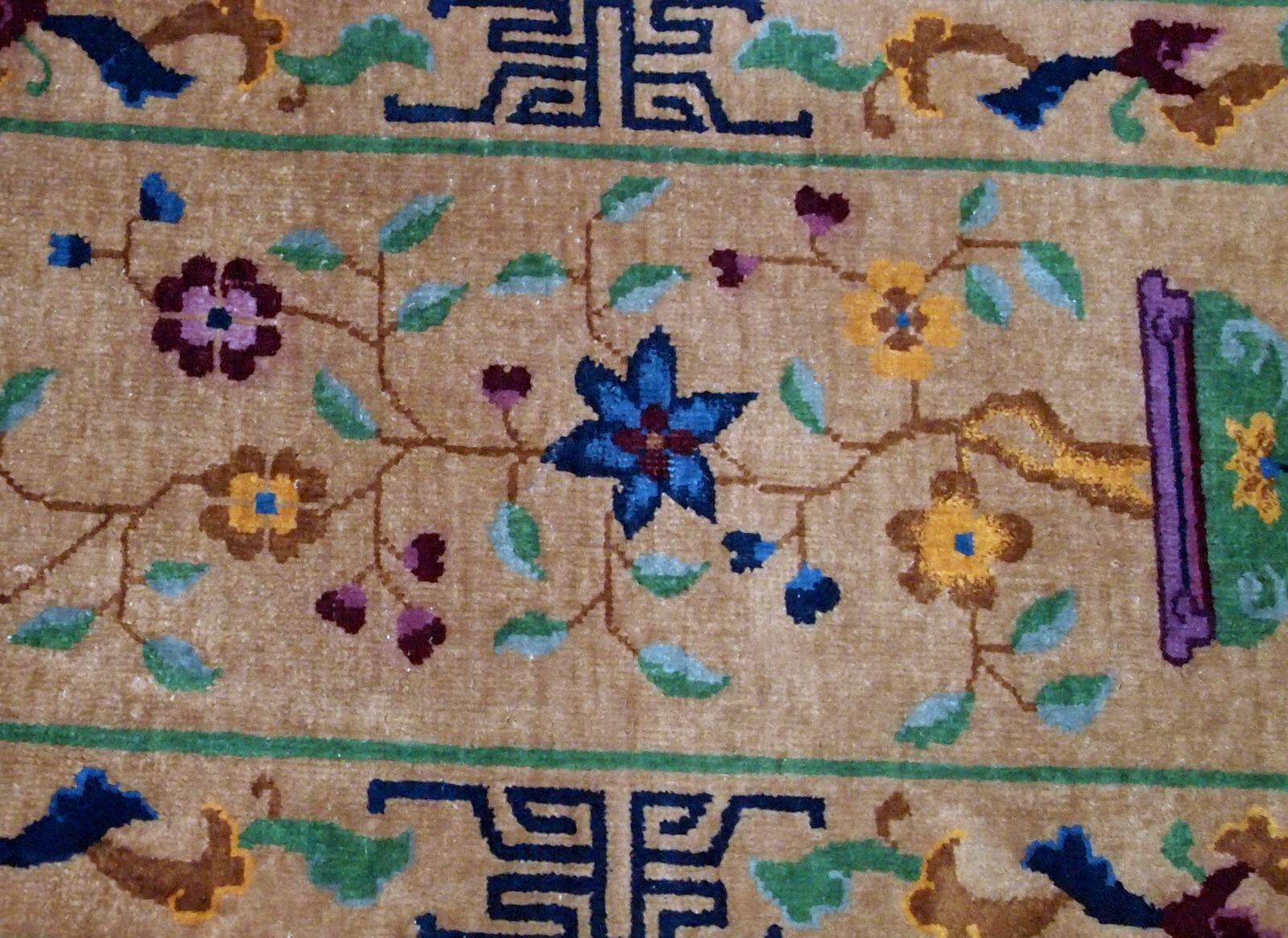 Handmade antique Art Deco Chinese rug in beige shade. The rug has Art Deco design with the vase and flowers. It is in original condition, has some low pile. 


 