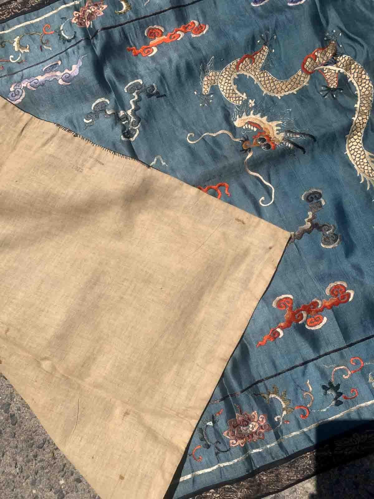 Handmade antique Chinese Dragon designed textile in silk. This tapestry is from the end of 19th century in original condition, it has some age discolorations.

-condition: original, some age discolorations,

-circa: 1870s,

-size: 2.6' x 3.8'