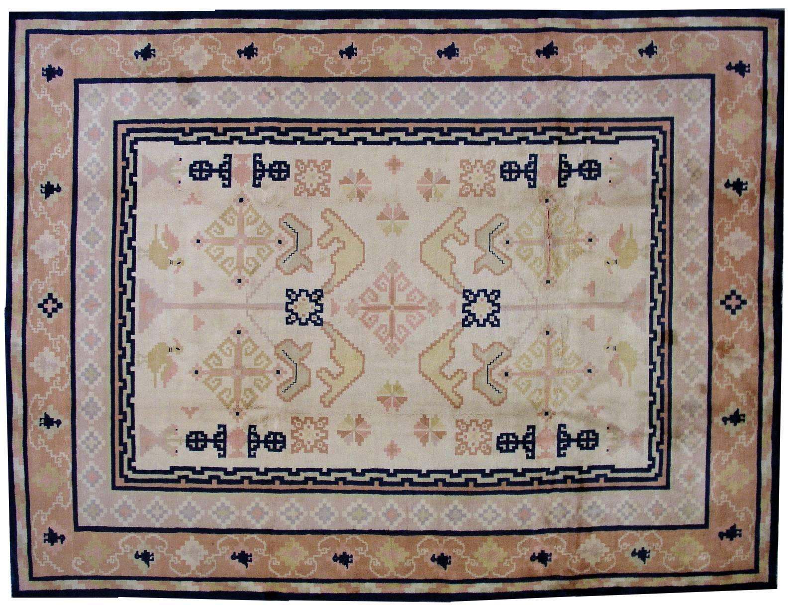 Antique Fete Chinese rug in original condition. The rug made in in soft pastel shades of peach, purple, beige and yellow, strong navy blue color is very contrasted on the details of the rug. The pattern on the rug is geometric which is quite unusual