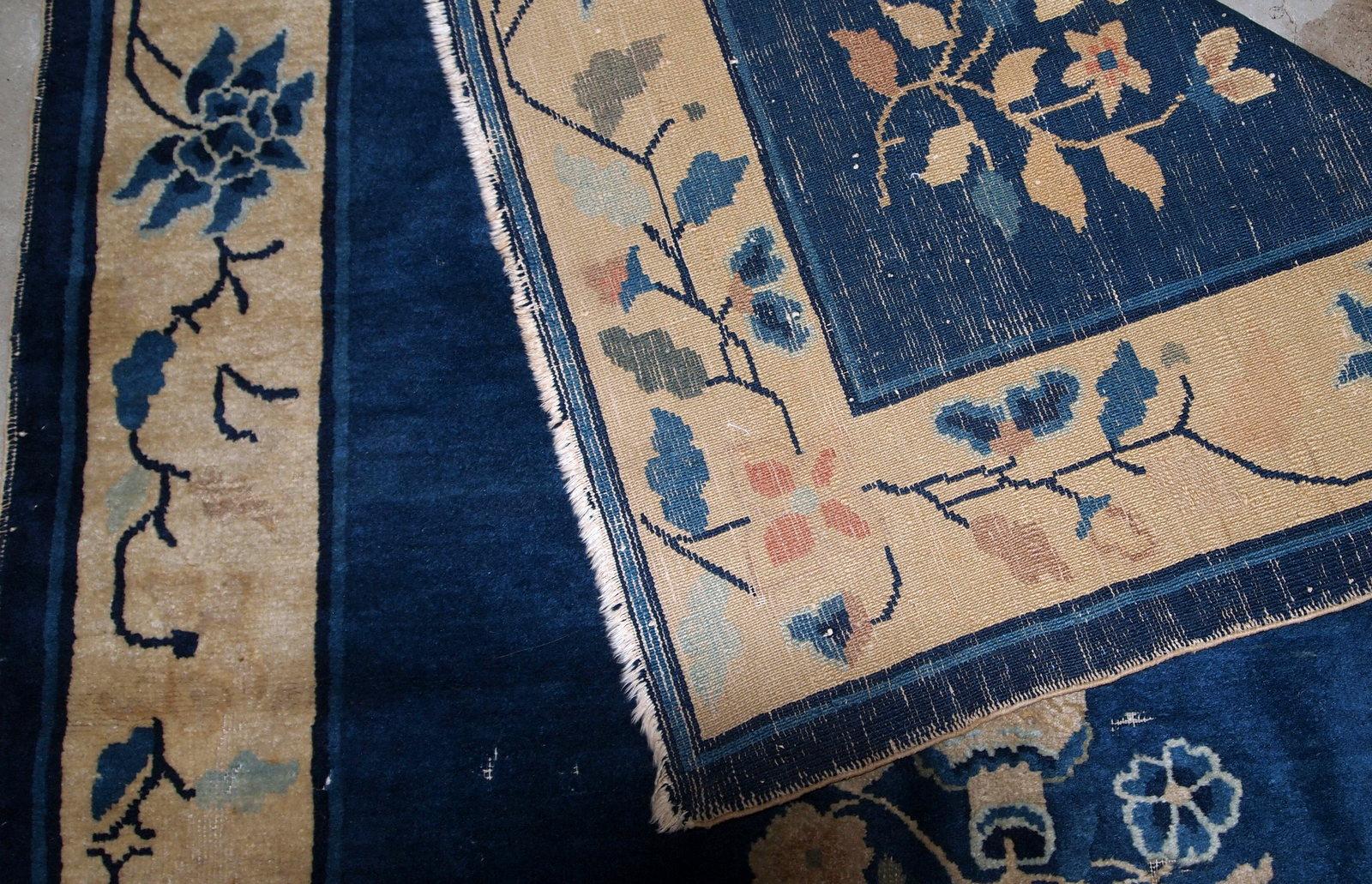 Handmade antique rug from Beijing, China, made in blue wool. The rug is in original condition, has some age wear. It is from the 1900s.

- Condition: original, some age wear,

- circa 1900s,

- Size: 4.1' x 6.4' (125cm x 195cm),

- Material: