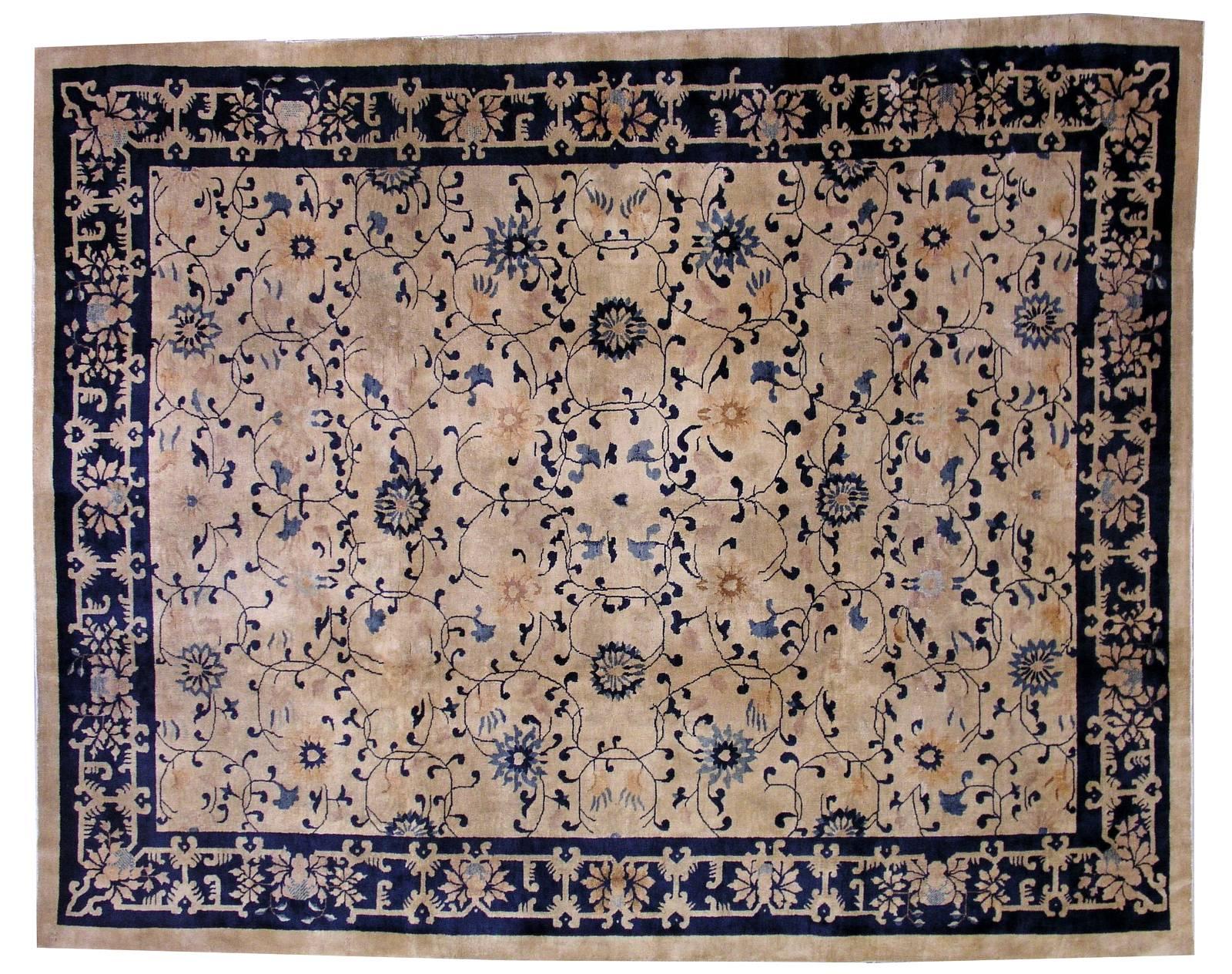 Antique Peking Chinese rug in good condition. The rug has very unusual design for typical Chinese Peking rugs. Very busy floral ornaments in blue shade covering beige background. The border is in navy blue shade. The rug is in good condition for its