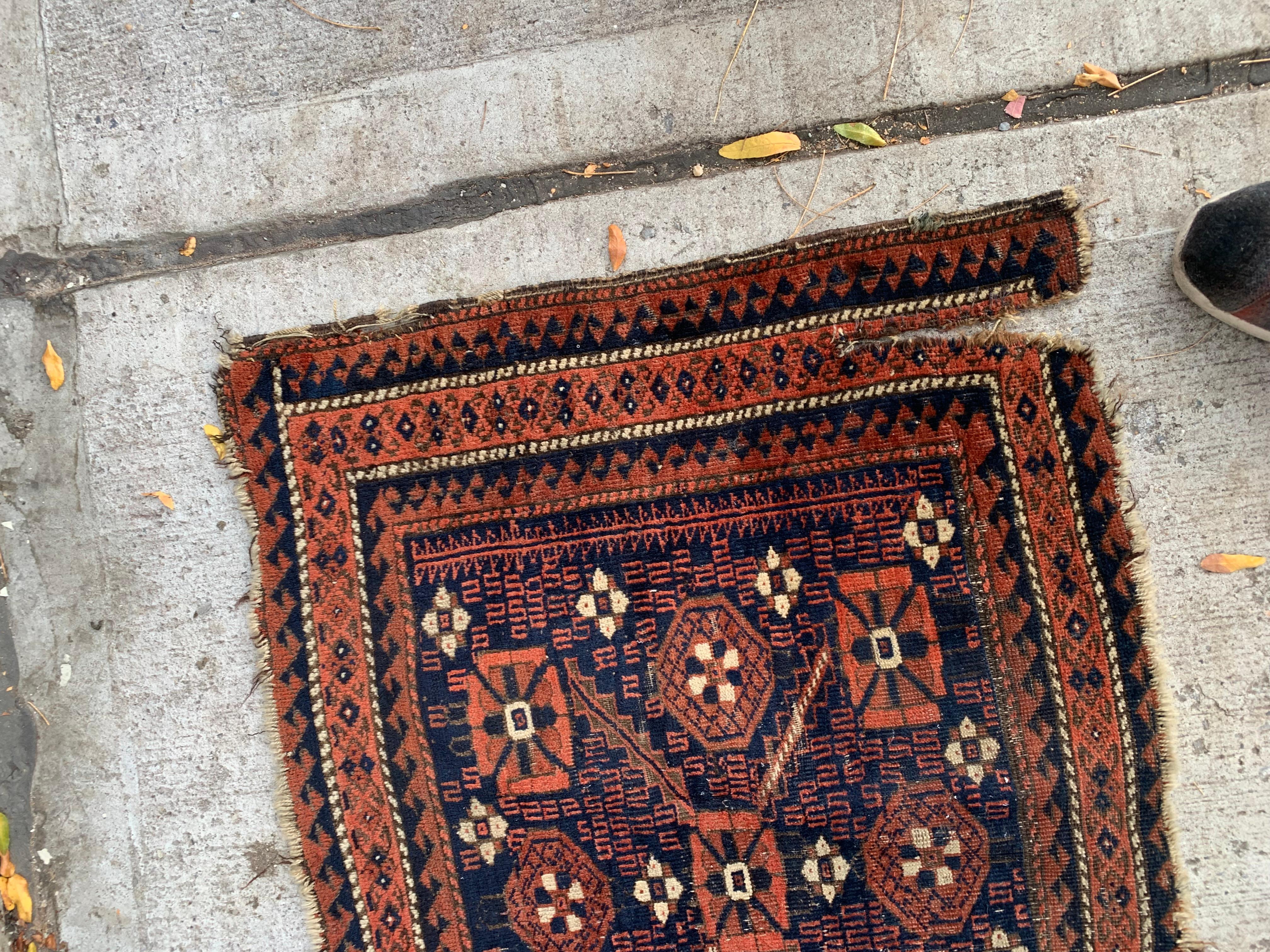 This handmade antique Afghan Baluch bagface, crafted in the 1880s, is a collectible piece that reflects the rich cultural traditions of the Baluch weavers. With its compact dimensions and striking geometric patterns, this bagface is a timeless