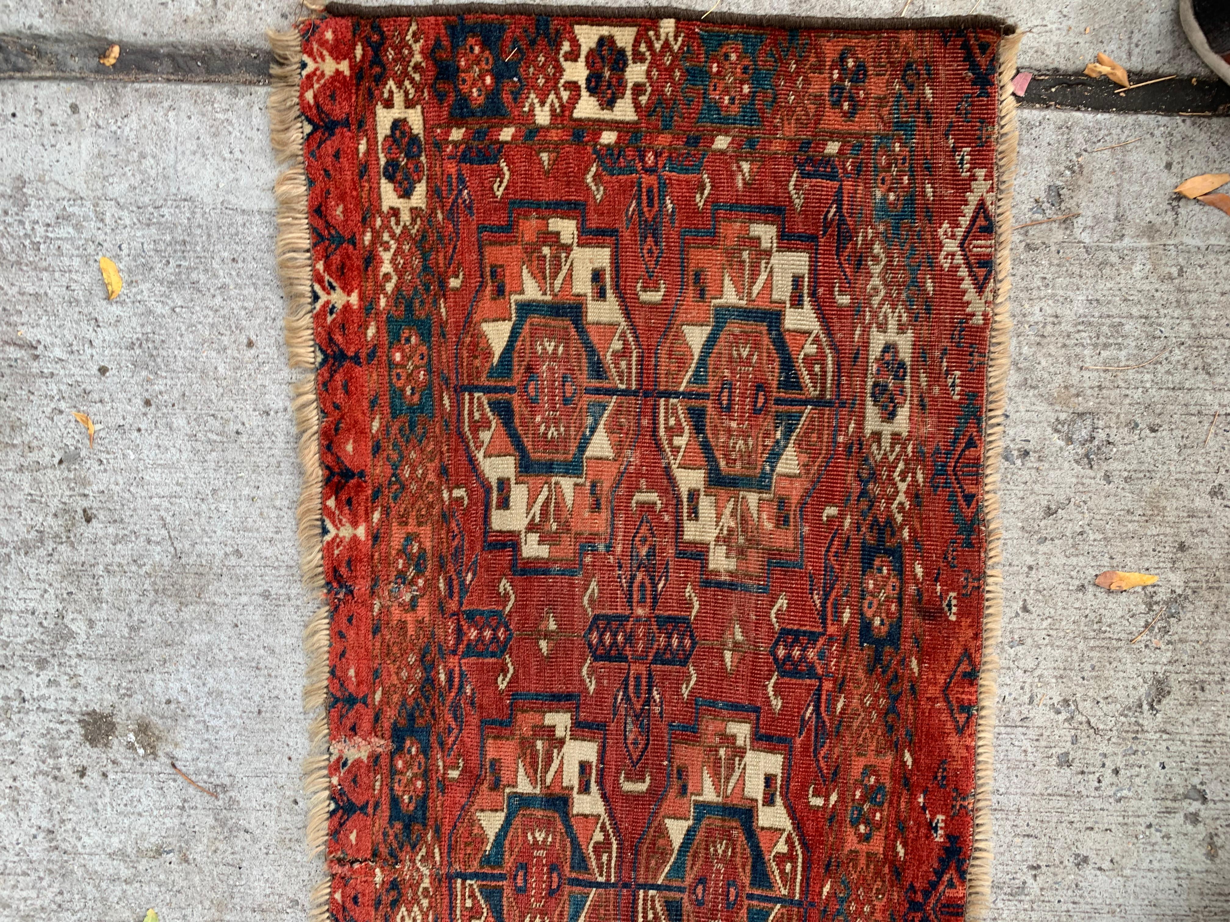 This handmade antique Turkmen Tekke Torba rug, crafted in the 1840s, is a rare and collectible piece that embodies the intricate weaving traditions of the Turkmen Tekke tribe. Its compact size and exquisite design make it a unique addition to any