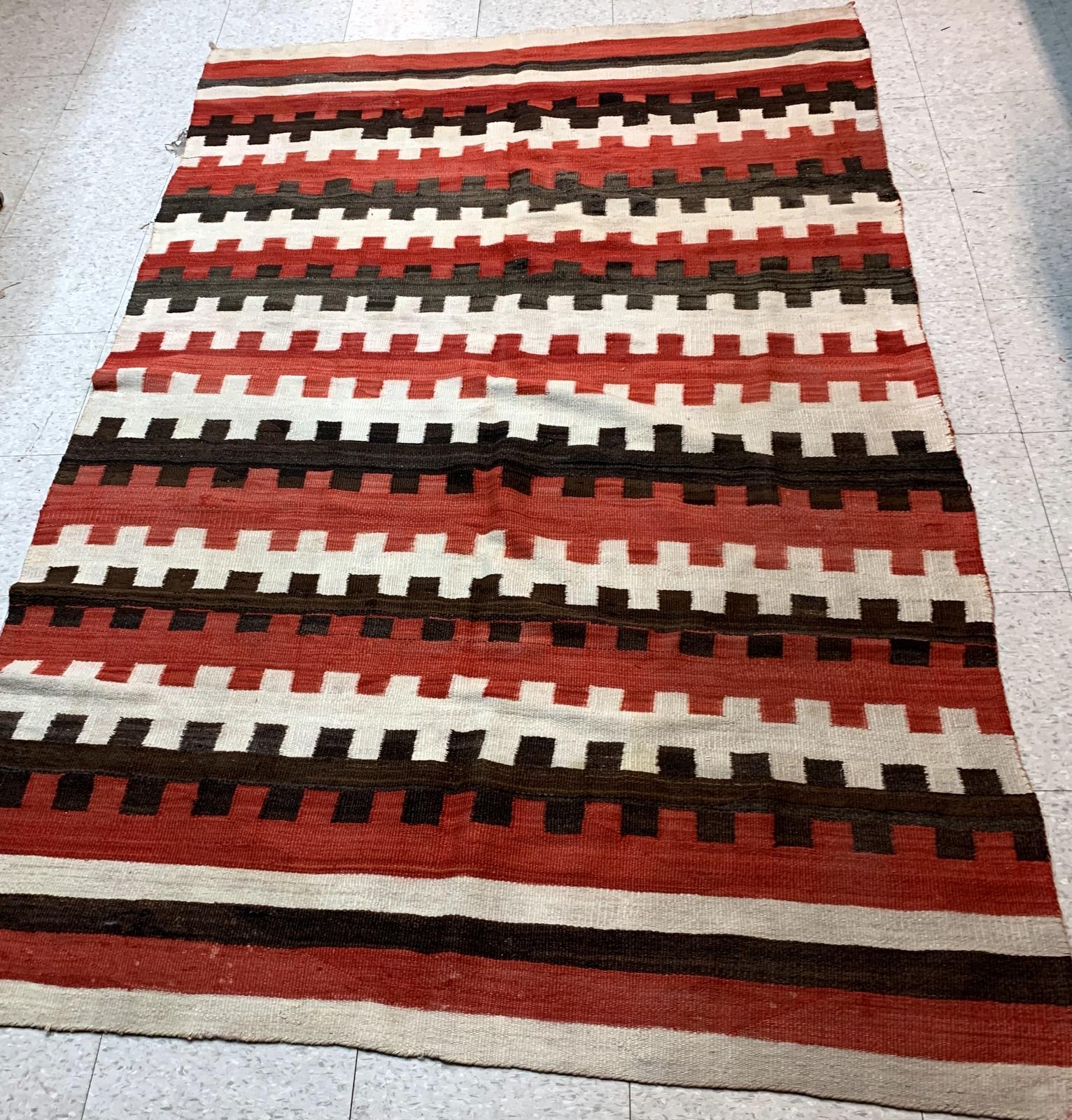 Antique hand-woven American-Indian Navajo blanket in original good condition. The blanket has been made in the end of 19th century in bright red, chocolate brown and white shades.

-condition: original good,

-circa: 1870s,

-size: 5.7' x 6.6'